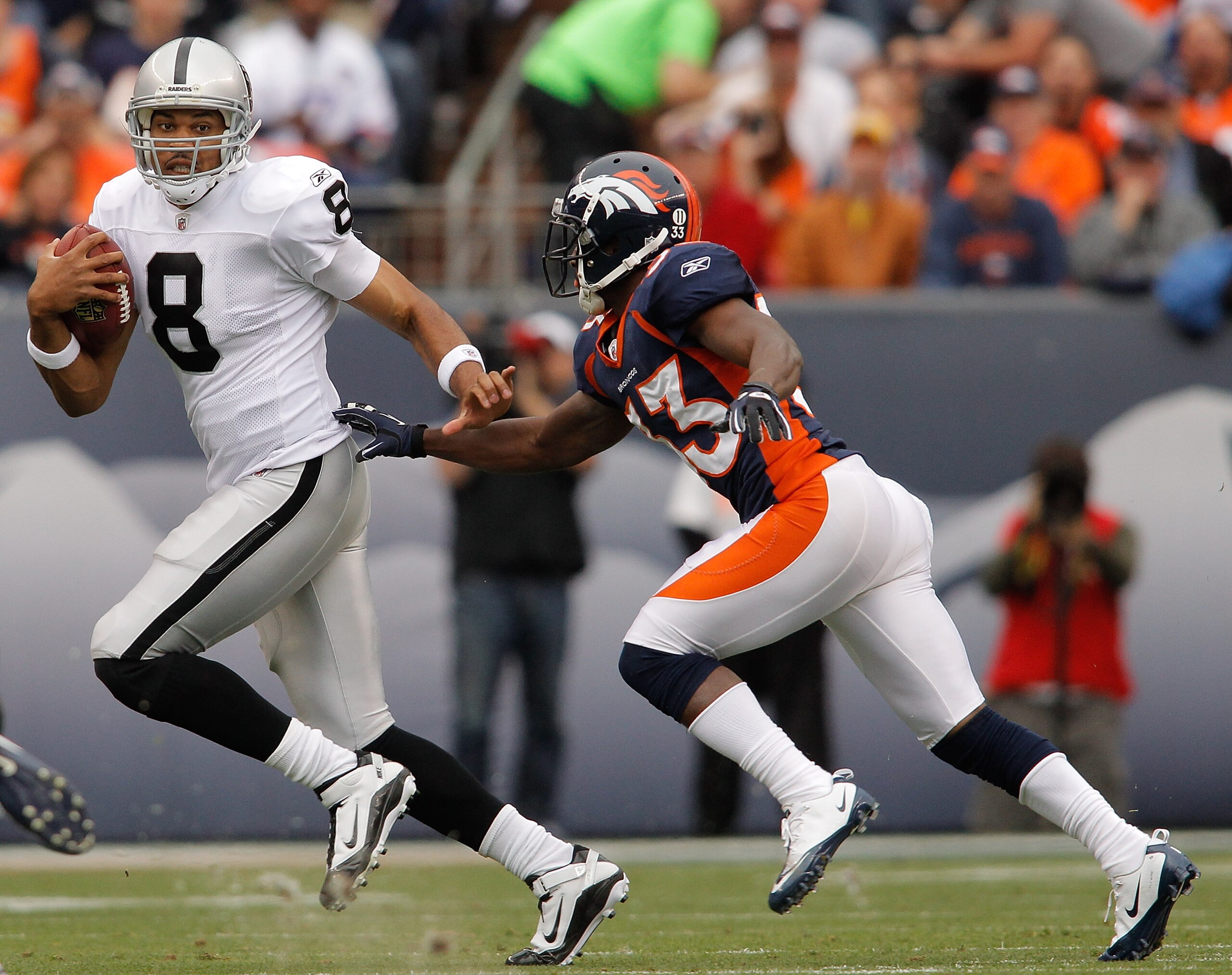 DENVER - OCTOBER 24:  Quarterback Jason Campbell #8 of the Oakland Raiders tries to elude cornerback Nate Jones #33 of the Denver Broncos in the first quarter at INVESCO Field at Mile High on October 24, 2010 in Denver, Colorado. (Photo by Justin Edmonds/
