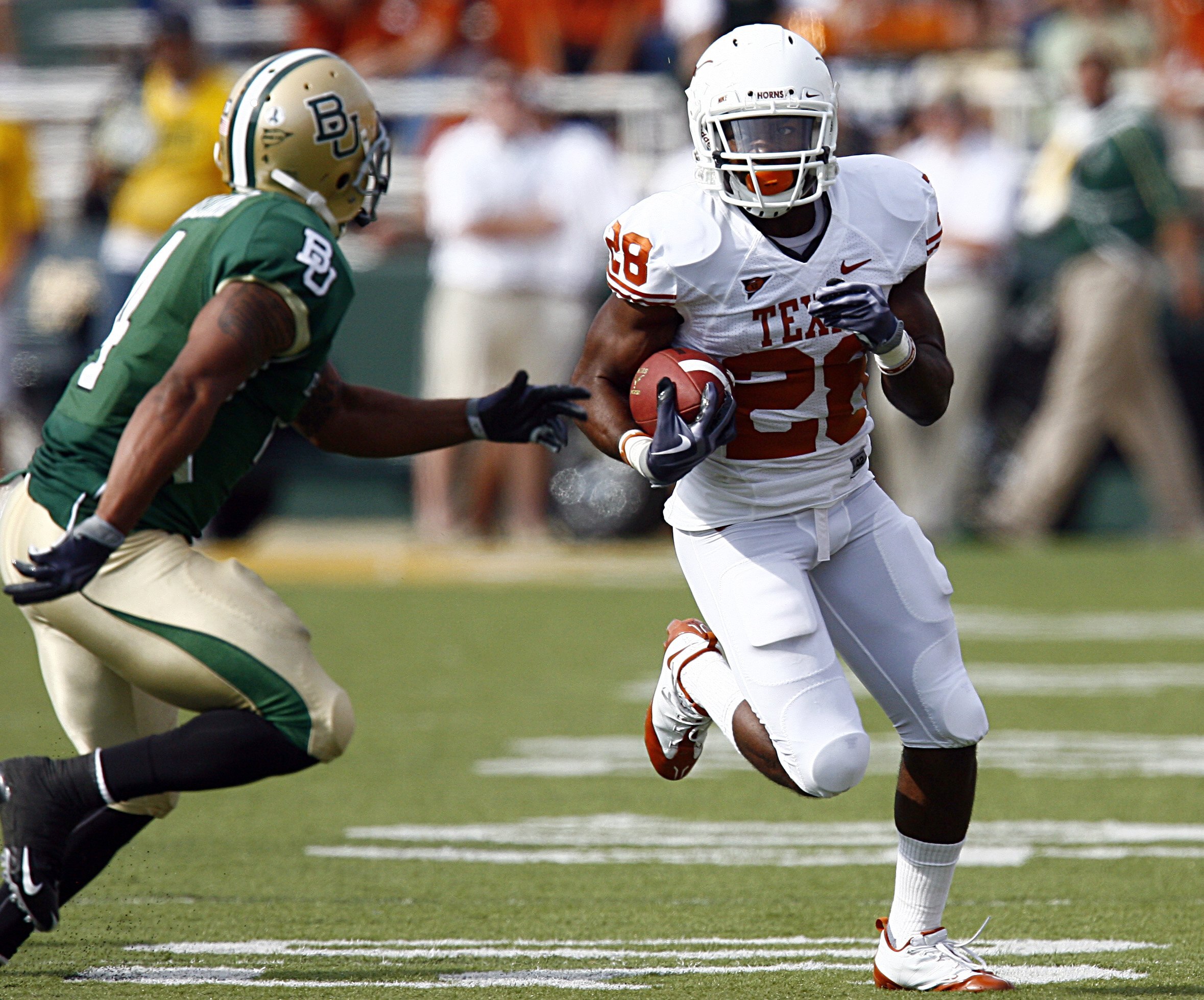 WACO, TX - NOVEMBER 14:  Running back Fozzy Whittaker #28 of the Texas Longhorns carries the ball in the first half against Byron Landon #14 of the Baylor Bears on November 14, 2009 at Floyd Casey Stadium in Waco, Texas.   The Longhorns beat the Bears 47-