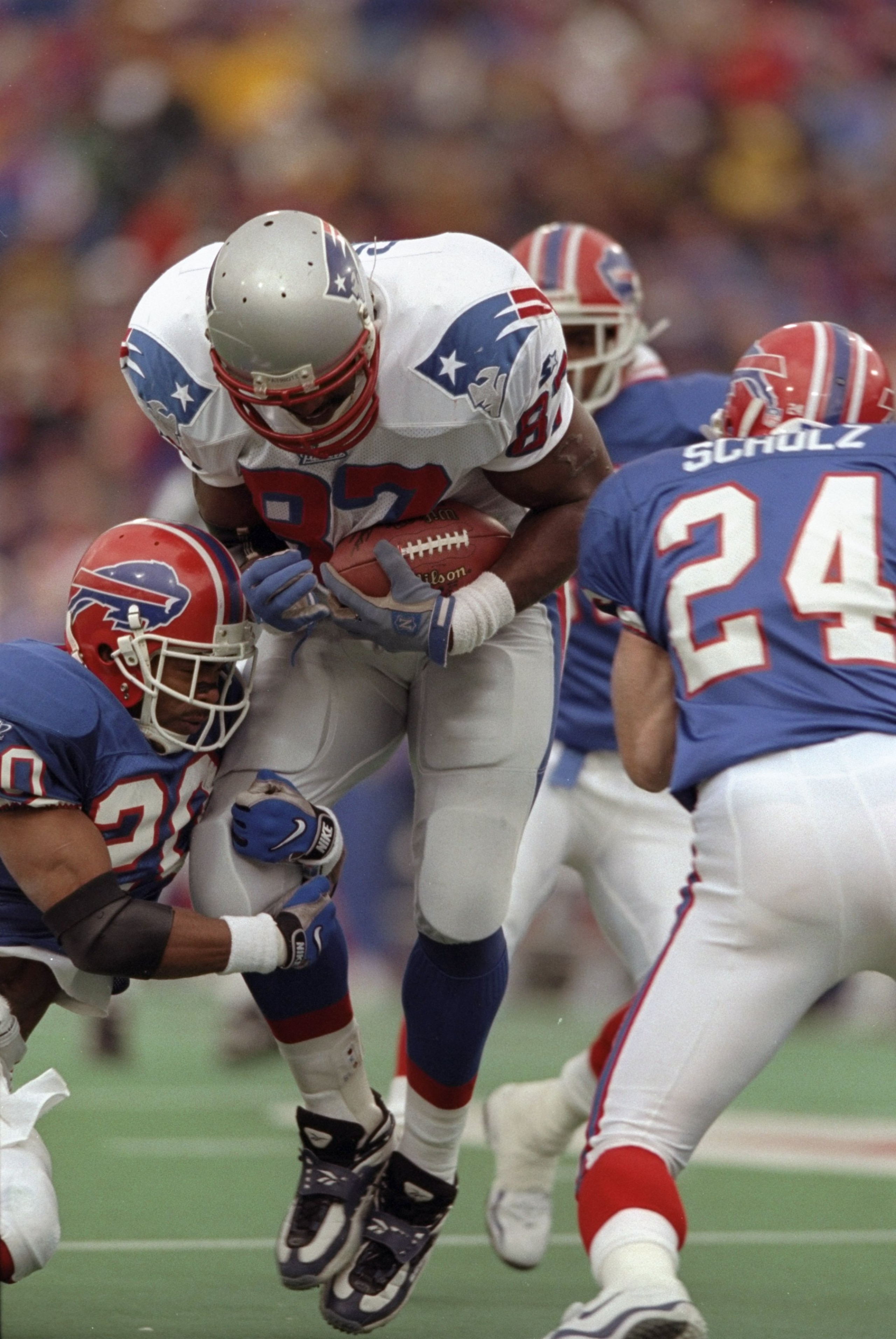 15 Nov 1998:  Tight end Ben Coates #87 of the New England Patriots is tackled by Henry Jones #20 and Kurt Schulz #24 of the Buffalo Bills during a game at the Rich Stadium in Orchard Park, New York. The Bills defeated the Patriots 13-10. Mandatory Credit: