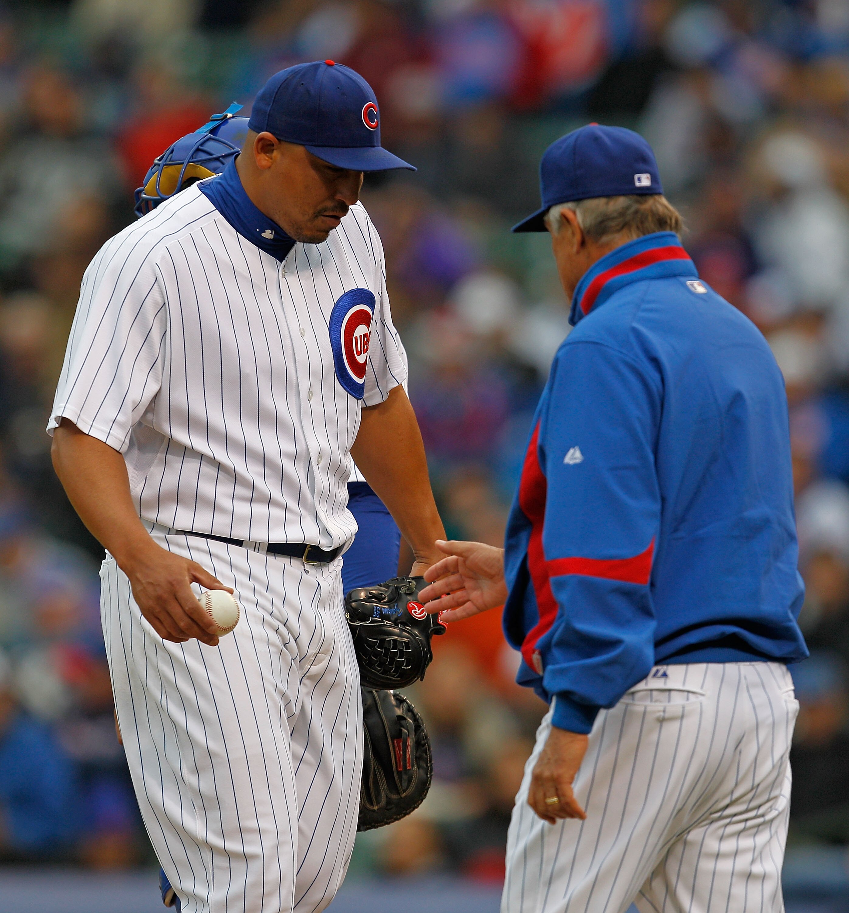 CHICAGO - MAY 12: Manager Lou Piniella #41 of the Chicago Cubs (R) takes out pitcher Carlos Zambrano #38 in the 8th inning with two out against the Florida Marlins at Wrigley Field on May 12, 2010 in Chicago, Illinois. The Cubs defeated the Marlins 4-3. (