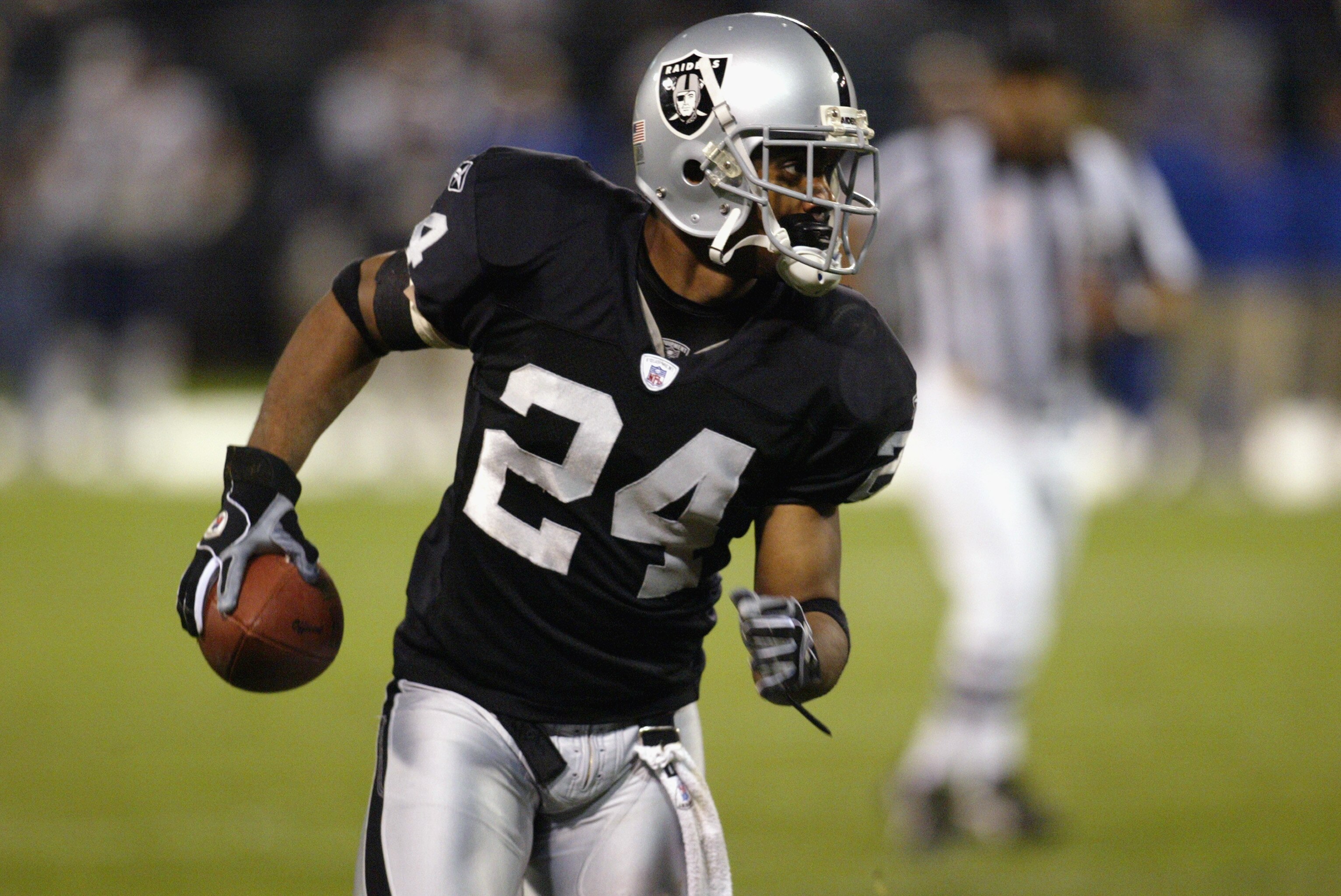 OAKLAND, CA - NOVEMBER 17:  Charles Woodson #24 of the Oakland Raiders runs with the ball during the game against the New England Patriots on November 17, 2002 at Network Associates Coliseum in Oakland, California. The Raiders defeated the Patriots 27-20.