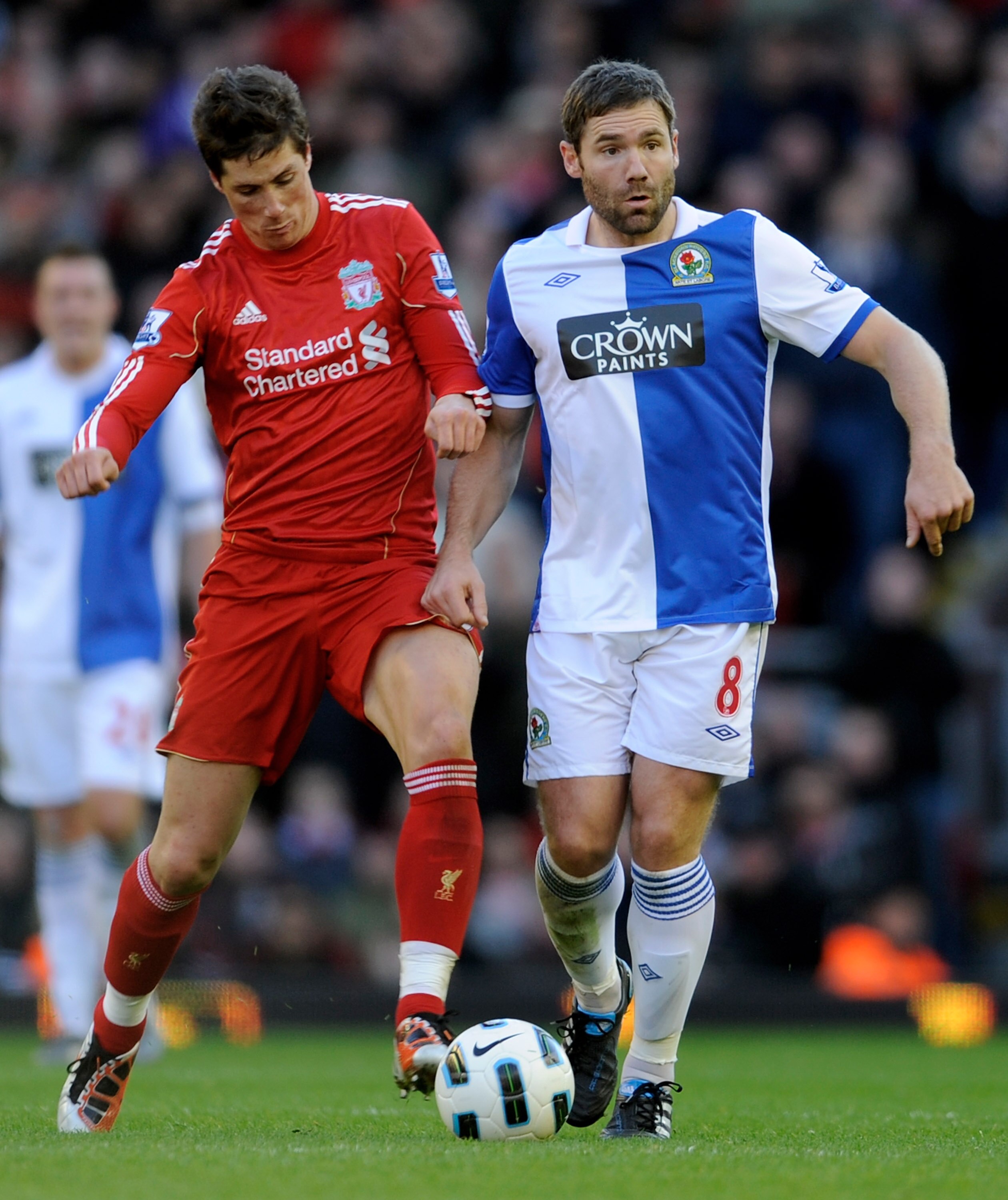 LIVERPOOL, ENGLAND - OCTOBER 24: Fernando Torres of Liverpool tussles for posession with David Dunn of Blackburn Rovers during the Barclays Premier League match between Liverpool and Blackburn Rovers at Anfield on October 24, 2010 in Liverpool, England. LIVERPOOL, ENGLAND - OCTOBER 24: Fernando Torres of Liverpool tussles for posession with David Dunn of Blackburn Rovers during the Barclays Premier League match between Liverpool and Blackburn Rovers at Anfield on October 24, 2010 in Liverpool, England.