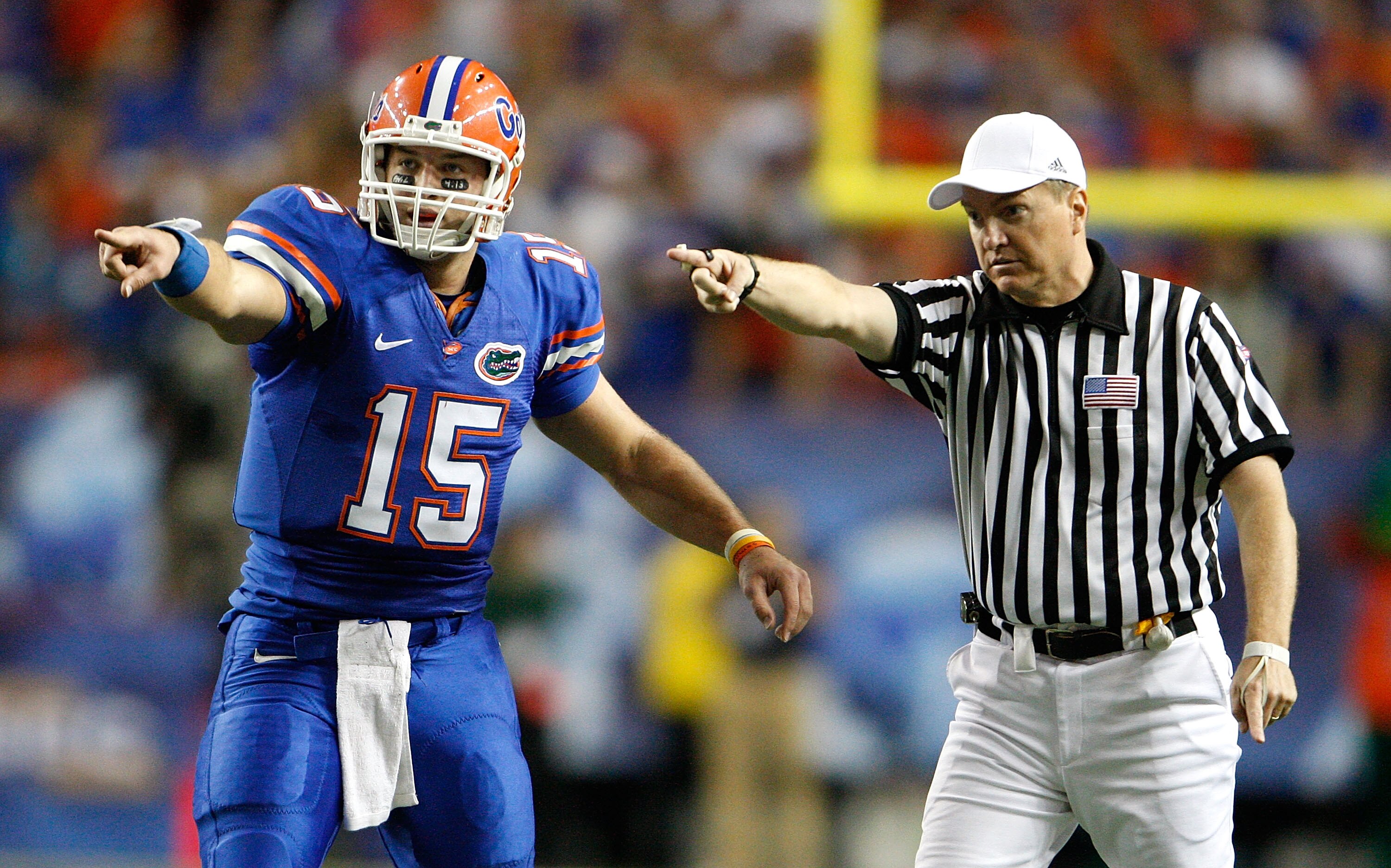 ATLANTA - DECEMBER 06:  Quarterback Tim Tebow #15 of the Florida Gators points with referee Tom Ritter at the first down against the Alabama Crimson Tide during the SEC Championship on December 6, 2008 at the Georgia Dome in Atlanta, Georgia.  (Photo by K