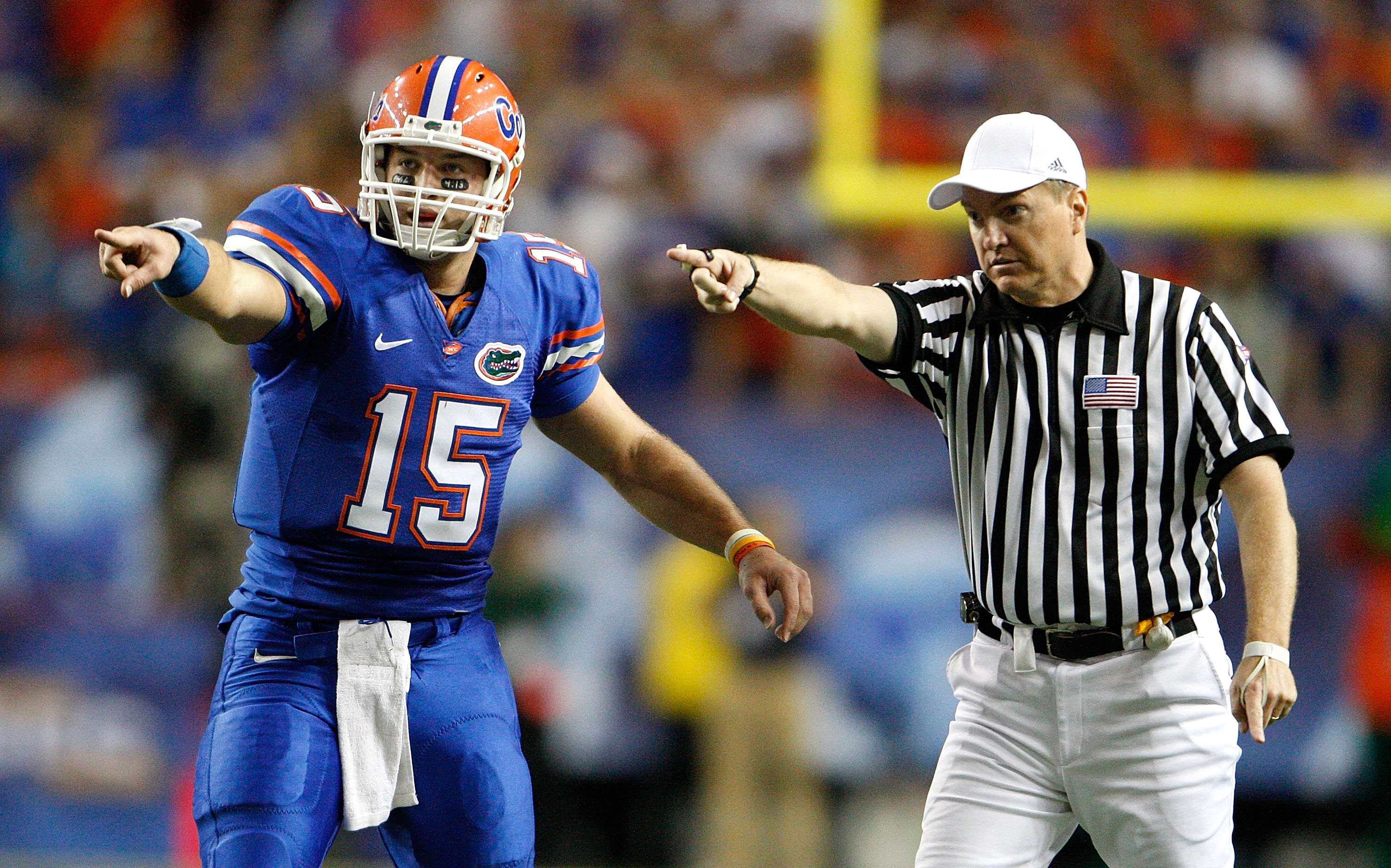 ATLANTA - DECEMBER 06:  Quarterback Tim Tebow #15 of the Florida Gators points with referee Tom Ritter at the first down against the Alabama Crimson Tide during the SEC Championship on December 6, 2008 at the Georgia Dome in Atlanta, Georgia.  (Photo by K