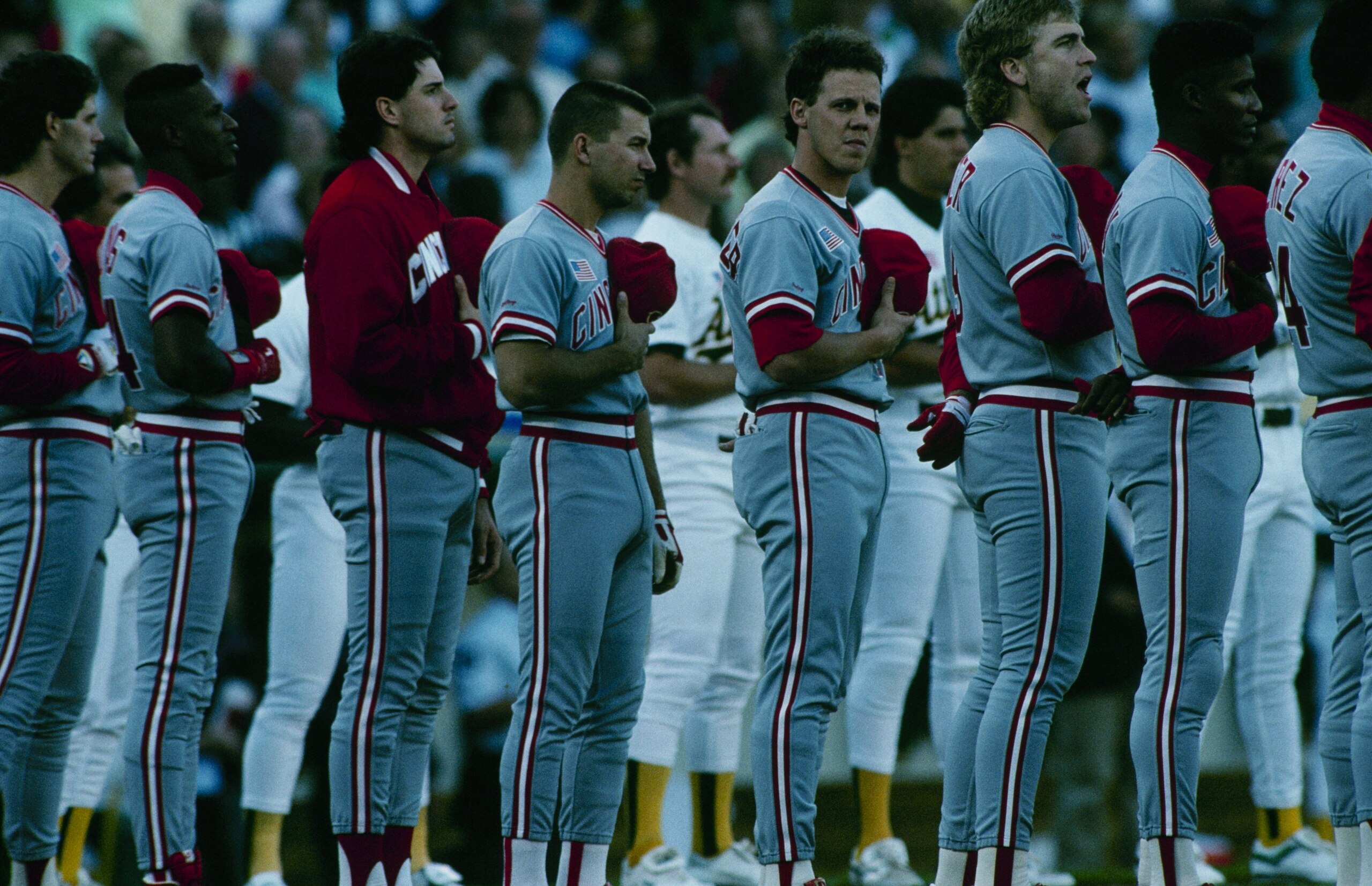 OAKLAND - OCTOBER 1990:  Cincinnati Reds players stand for the National Anthem before a 1990 World Series game against the Oakland Athletics at Oakland Coliseum in October 1990 in Oakland, California. (Photo by Otto Greule Jr/Getty Images)