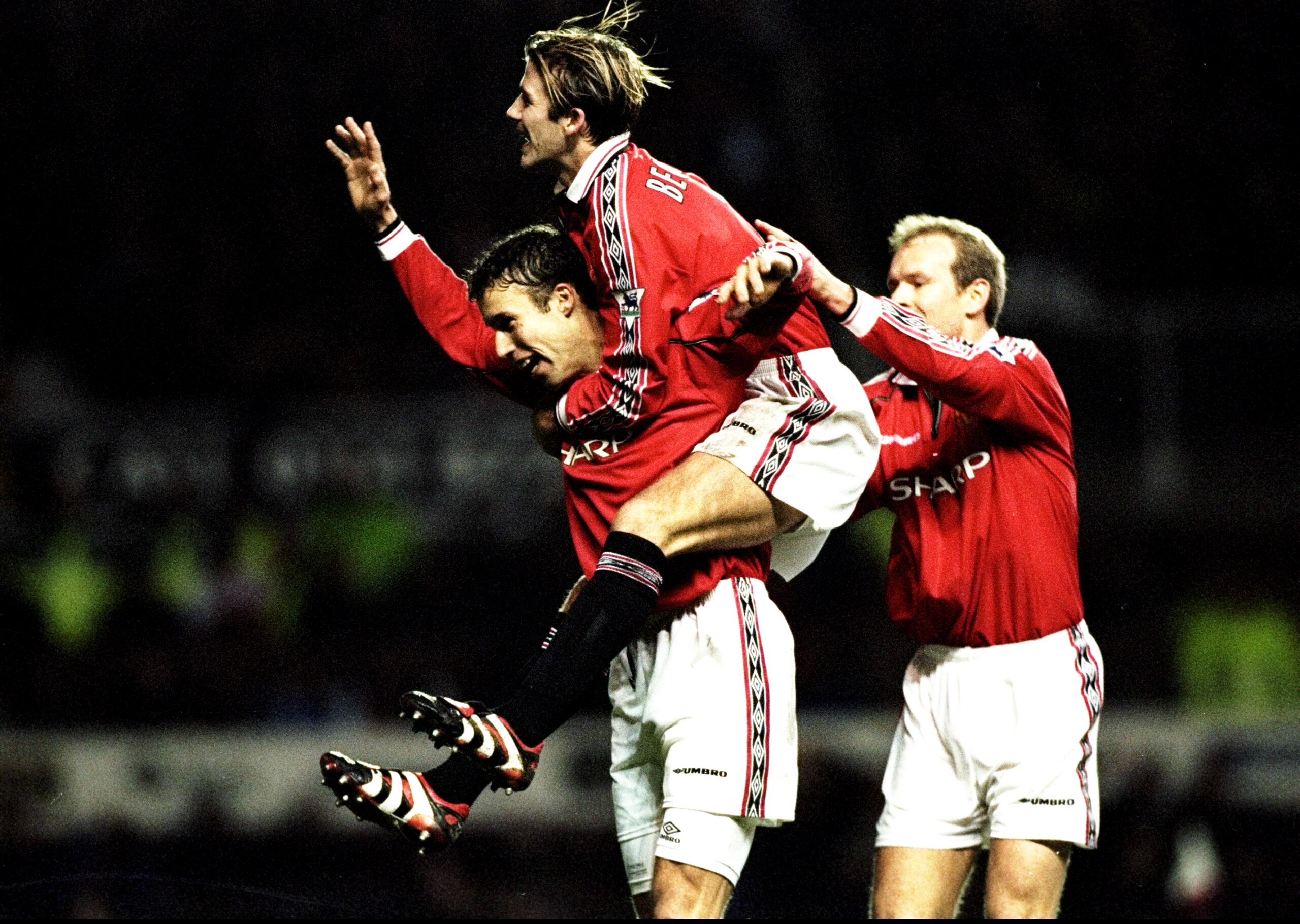 26 Dec 1998:  Ronny Johnsen of Manchester United is congratulated by team mates David Beckham and Henning Berg after scoring against Nottingham Forest in the FA Carling Premiership match at Old Trafford in Manchester, England. United won 3-0. \ MandatoryC