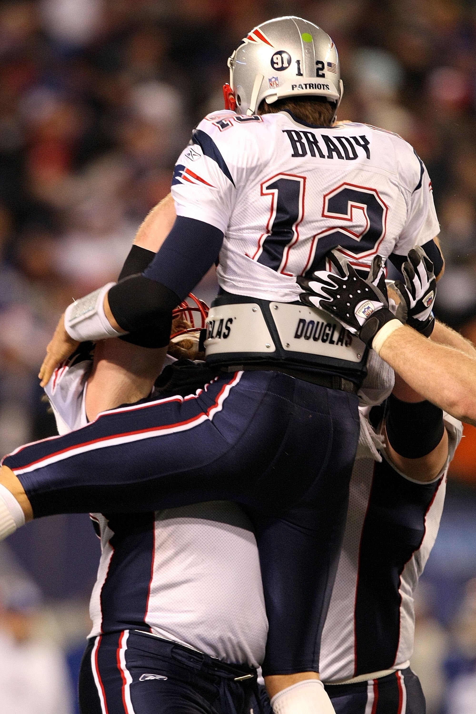 EAST RUTHERFORD, NJ - DECEMBER 29:  Tom Brady #12 and the New England Patriots celebrates with his teammates after throwing his 50th touchdown of the season breaking the all time season high for touchdowns thrown in a season while playing against the New