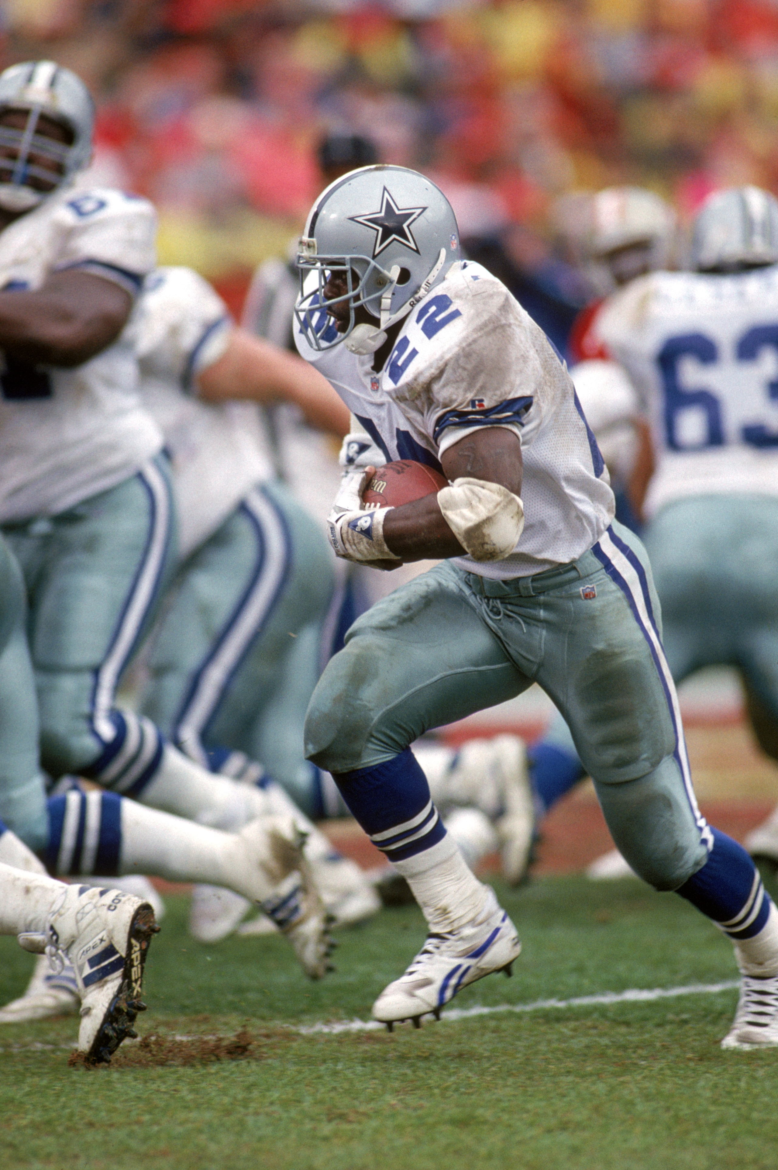 SAN FRANCISCO - JANUARY 17:  Running back Emmitt Smith #22 of the Dallas Cowboys hustles for yards during the 1992 NFC Conference Championship game against the San Francisco 49ers at Candlestick Park on January 17, 1993 in San Francisco, California.  The