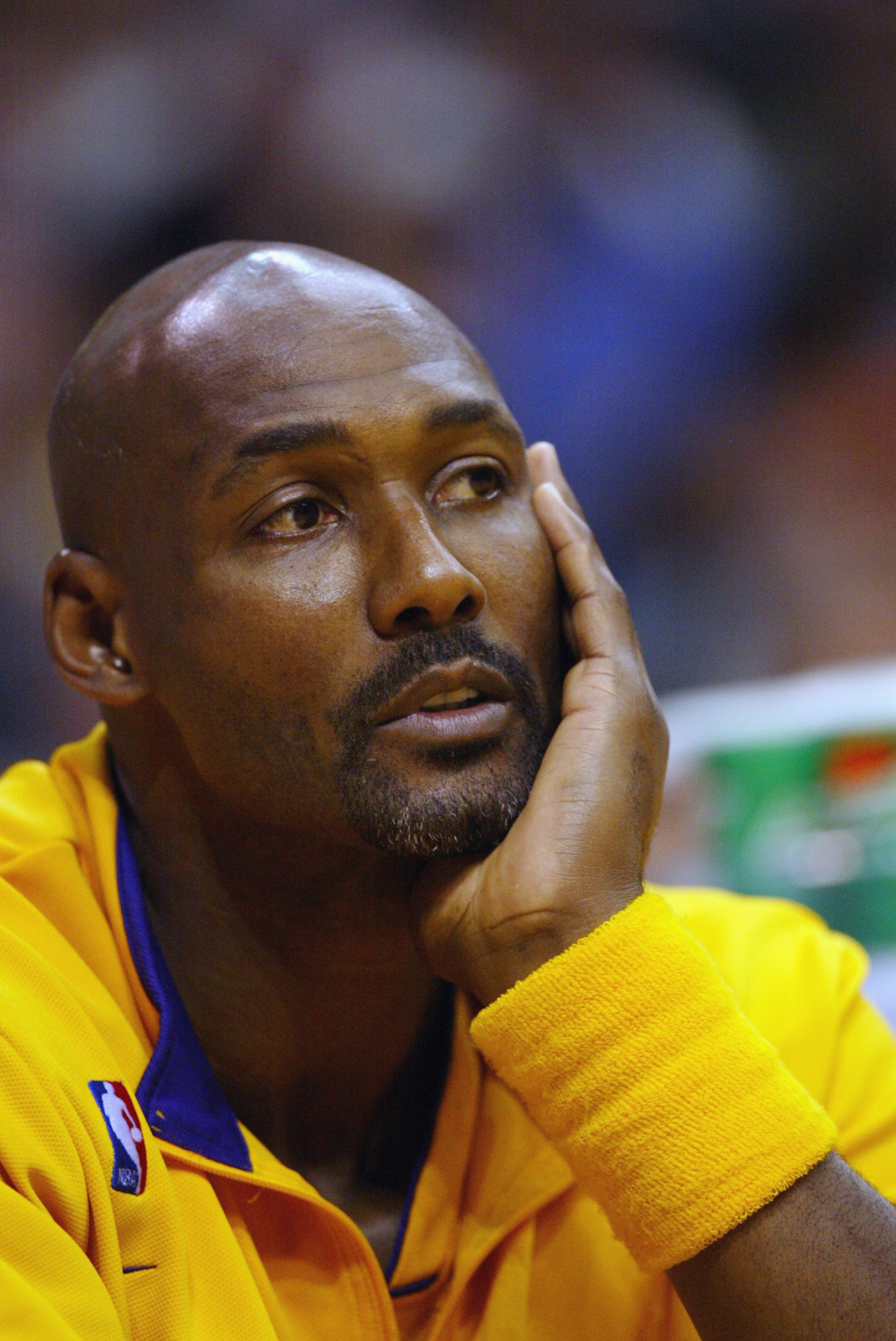 LOS ANGELES- MAY 25:  Karl Malone #20 of the Los Angeles Lakers looks on from the bench against the Minnesota Timberwolves in Game three of the Western Conference Finals during the 2004 NBA Playoffs at Staples Center on May 25, 2004 in Los Angeles, Califo