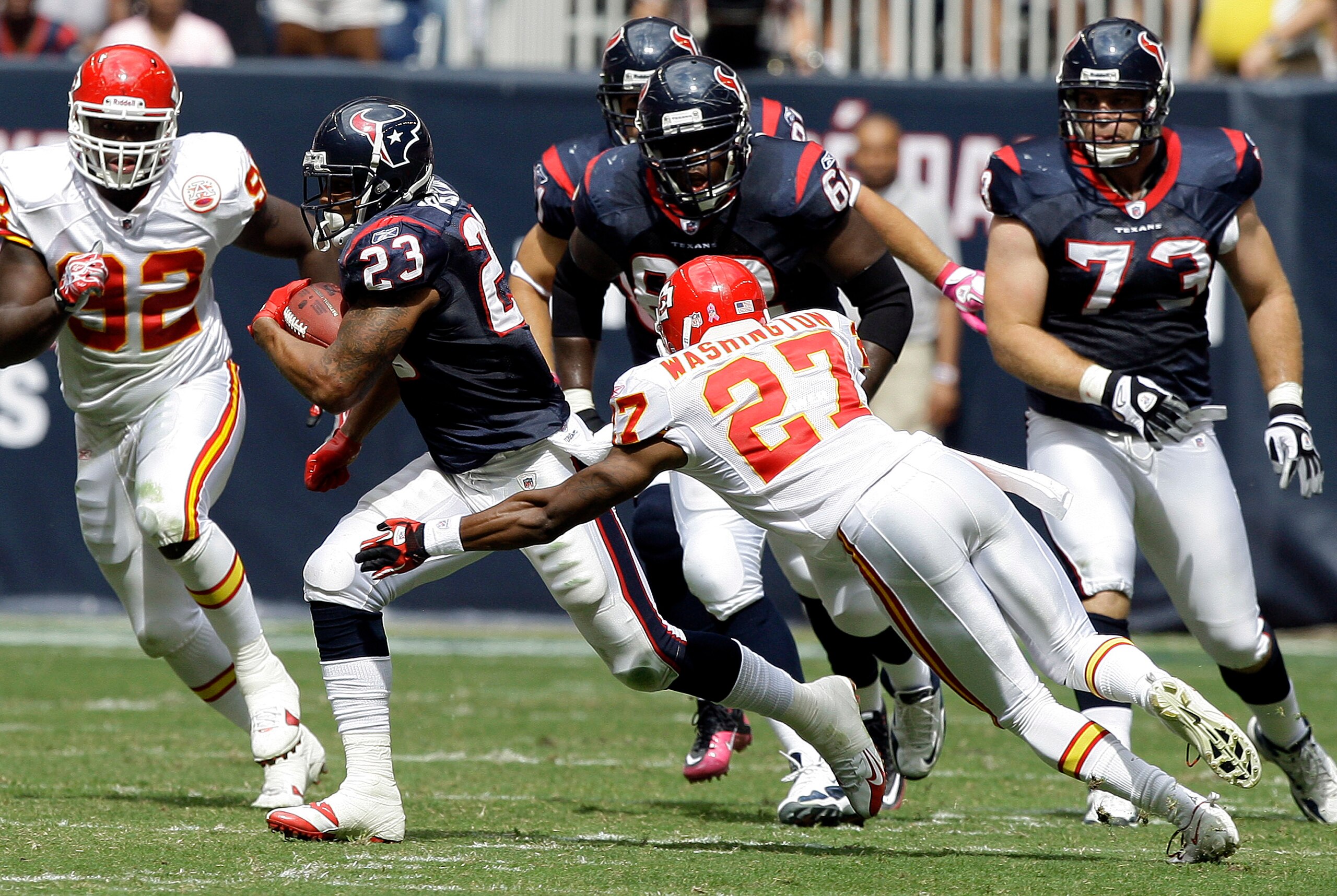 HOUSTON - OCTOBER 17:  Adrian Foster #23 of the Houston Texans runs past cornerback Donald Washington #27 of the Kansas City Chiefs at Reliant Stadium on October 17, 2010 in Houston, Texas.  (Photo by Bob Levey/Getty Images)