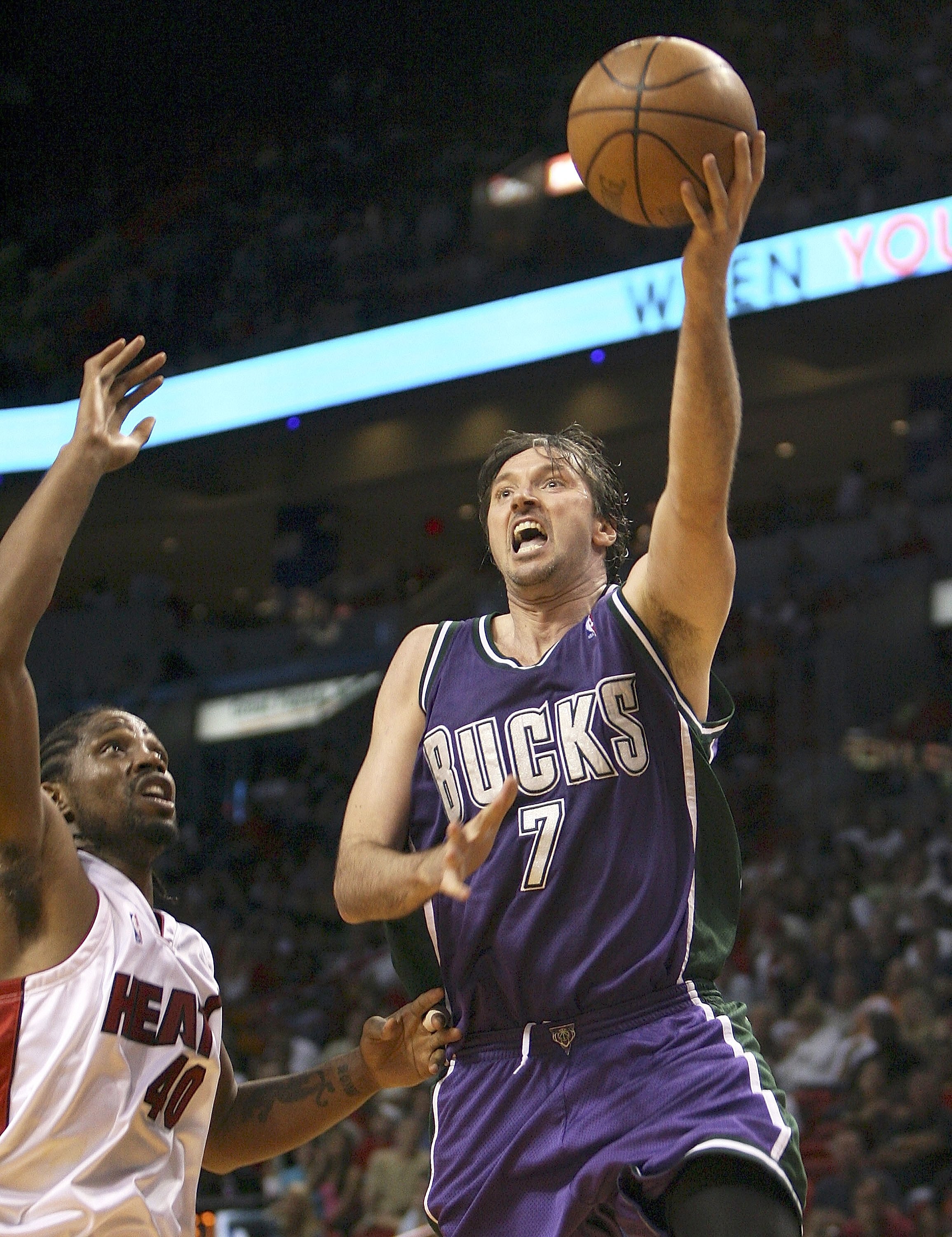 MIAMI - APRIL 04:  Toni Kukoc #7 of the Milwaukee Bucks scores over Udonis Haslem #40 of the Miami Heat on April 4, 2006 at American Airlines Arena in Miami, Florida.  NOTE TO USER:  User expressly acknowledges and agrees that, by downloading and/or using