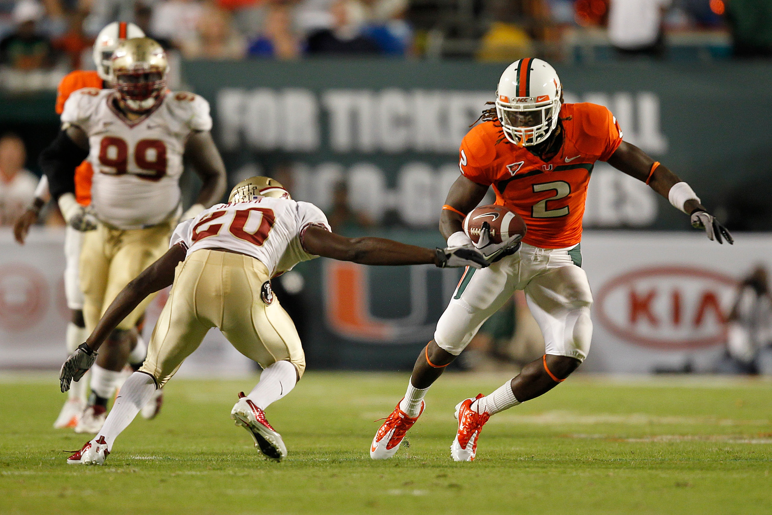 MIAMI, FL - OCTOBER 9: Graig Cooper #2 of the Miami Hurricanes runs with the ball and eludes the tackloe of Lamarcus Joyner #20 of the Florida State Seminoles on October 9, 2010 at Sun Life Stadium in Miami, Florida. (Photo by Joel Auerbach/Getty Images) MIAMI, FL - OCTOBER 9: Graig Cooper #2 of the Miami Hurricanes runs with the ball and eludes the tackloe of Lamarcus Joyner #20 of the Florida State Seminoles on October 9, 2010 at Sun Life Stadium in Miami, Florida. (Photo by Joel Auerbach/Getty Images)