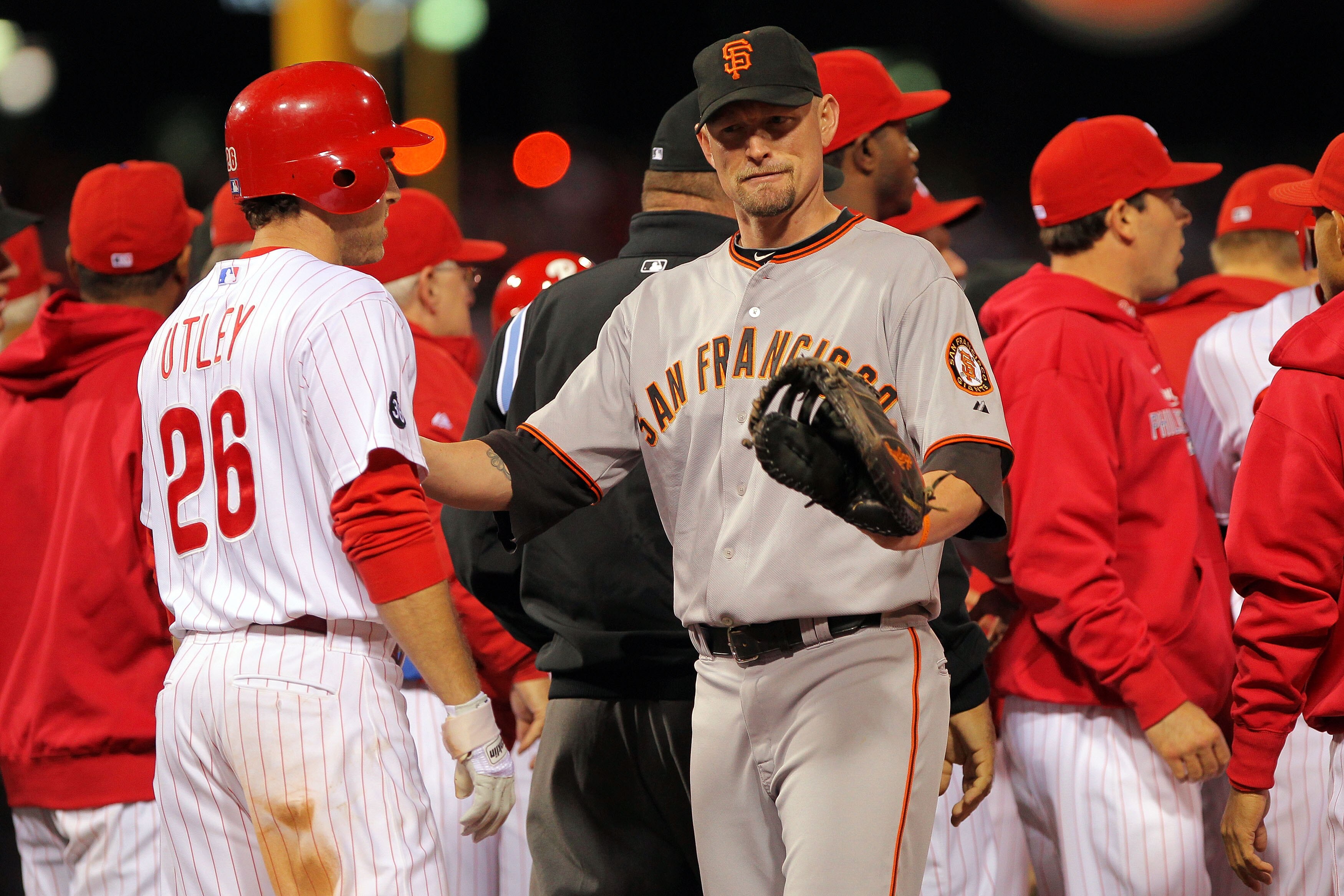 PHILADELPHIA - OCTOBER 23:  Chase Utley #26 of the Philadelphia Phillies is held back by Aubrey Huff #17 of the San Francisco Giants after being hit by a pitch in the third inning of Game Six of the NLCS during the 2010 MLB Playoffs at Citizens Bank Park