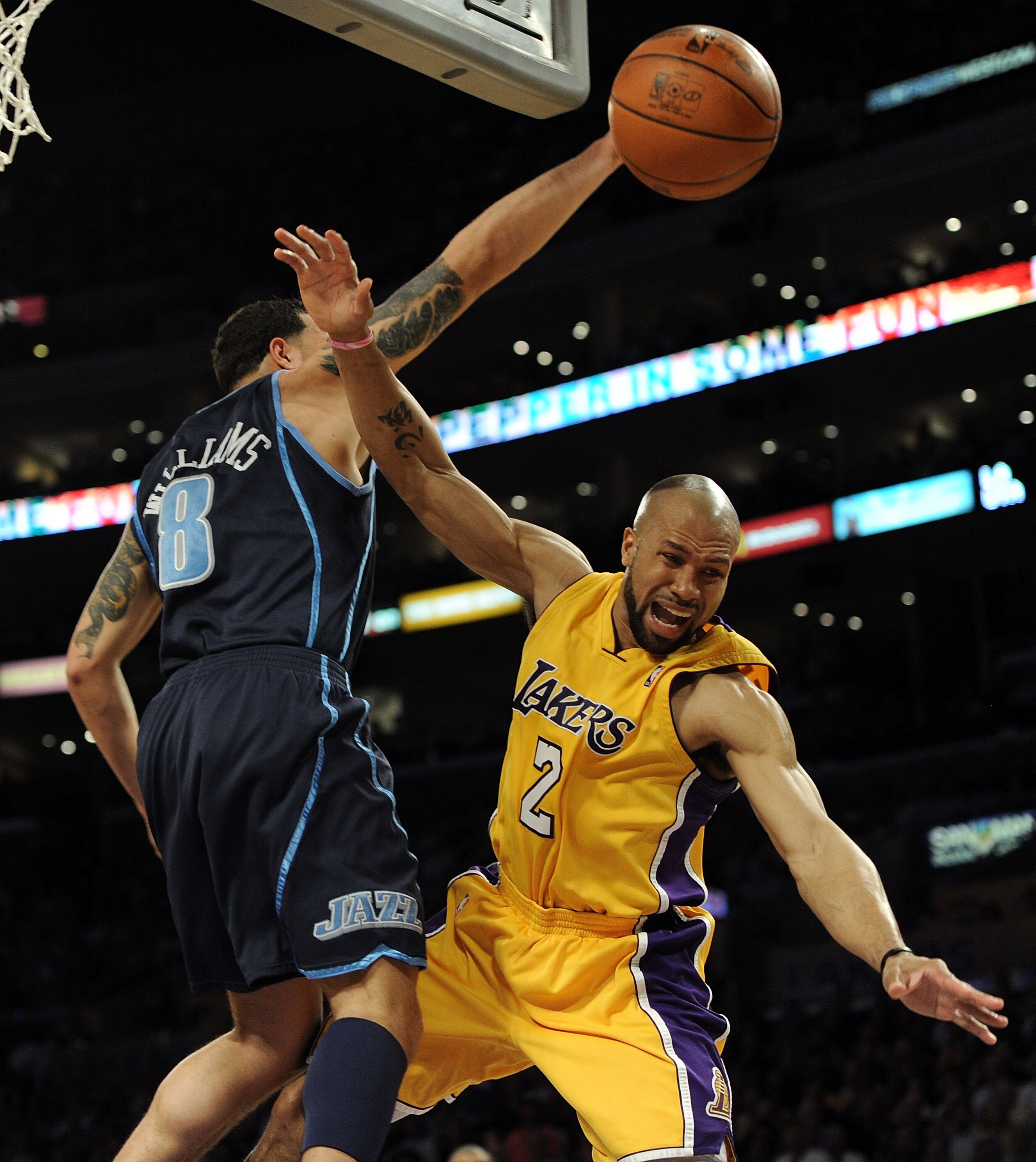 LOS ANGELES, CA - MAY 04:  Derek Fisher #2 of the Los Angeles Lakers flies through the air against Deron Williams #8 of the Utah Jazz in the first half during Game Two of the Western Conference Semifinals of the 2010 NBA Playoffs at Staples Center on May 