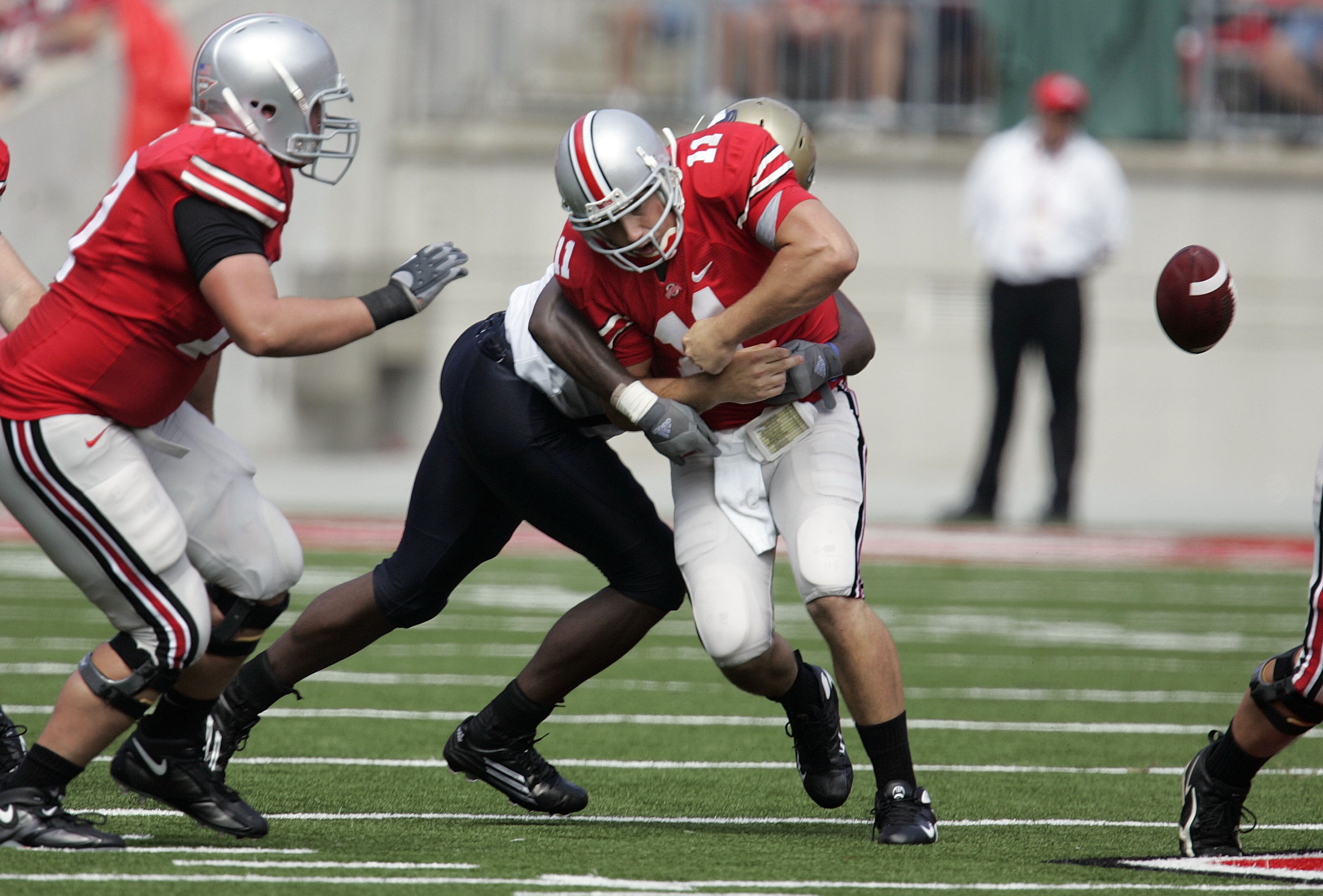COLUMBUS - SEPTEMBER 8:  Quarterback Rob Schoenhoft #11 of the Ohio State Buckeyes fumbles the ball as he is tackled by Doug Williams #54 of the Akron Zips on September 8, 2007 at Ohio Stadium in Columbus, Ohio. Ohio State defeated Akron 20-2.  (Photo by