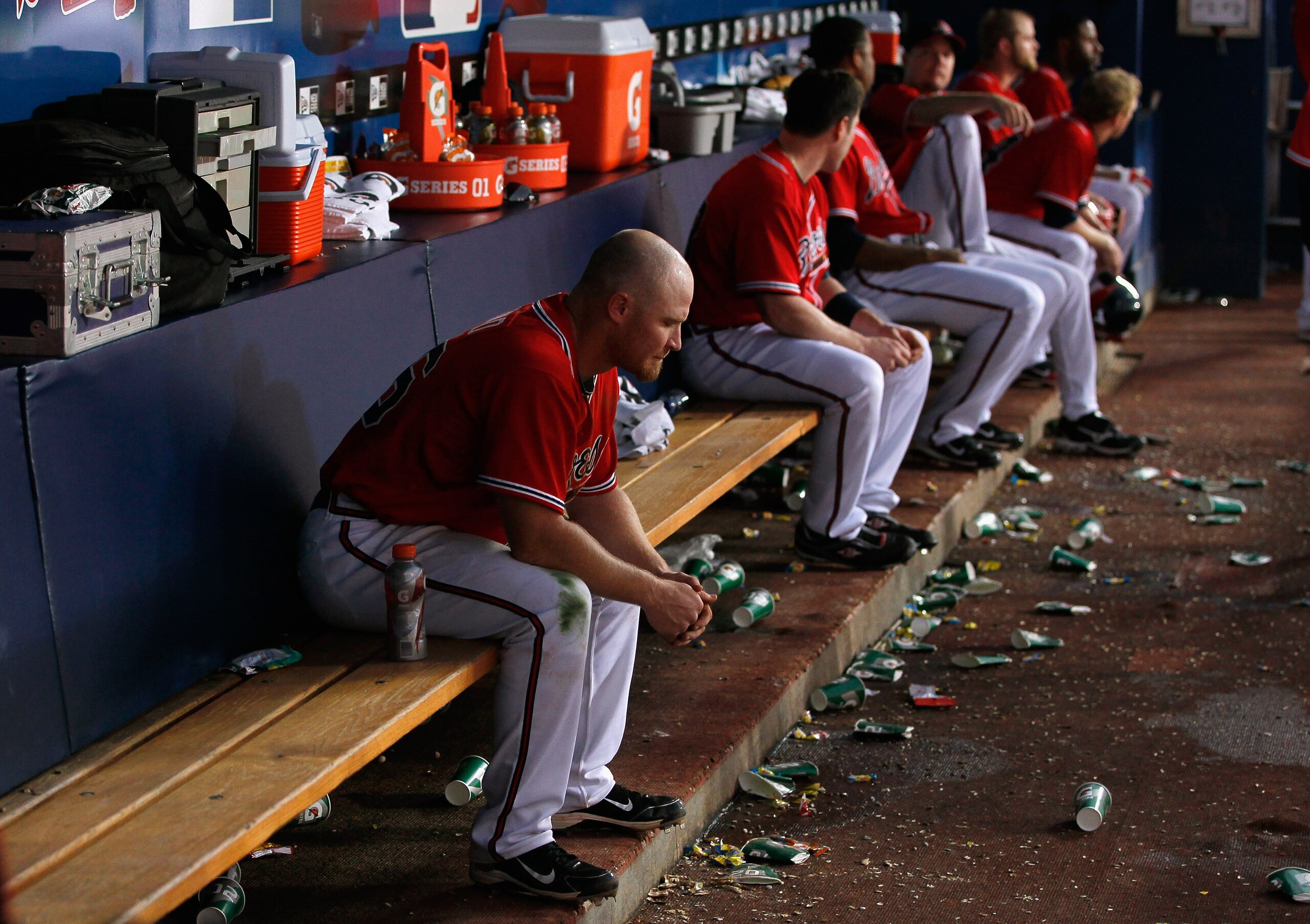 ATLANTA - OCTOBER 10:  Brooks Conrad #26 of the Atlanta Braves sits in the dugout in the eighth inning after pop-flying a bunt for an out against the San Francisco Giants during Game Three of the NLDS of the 2010 MLB Playoffs at Turner Field on October 10