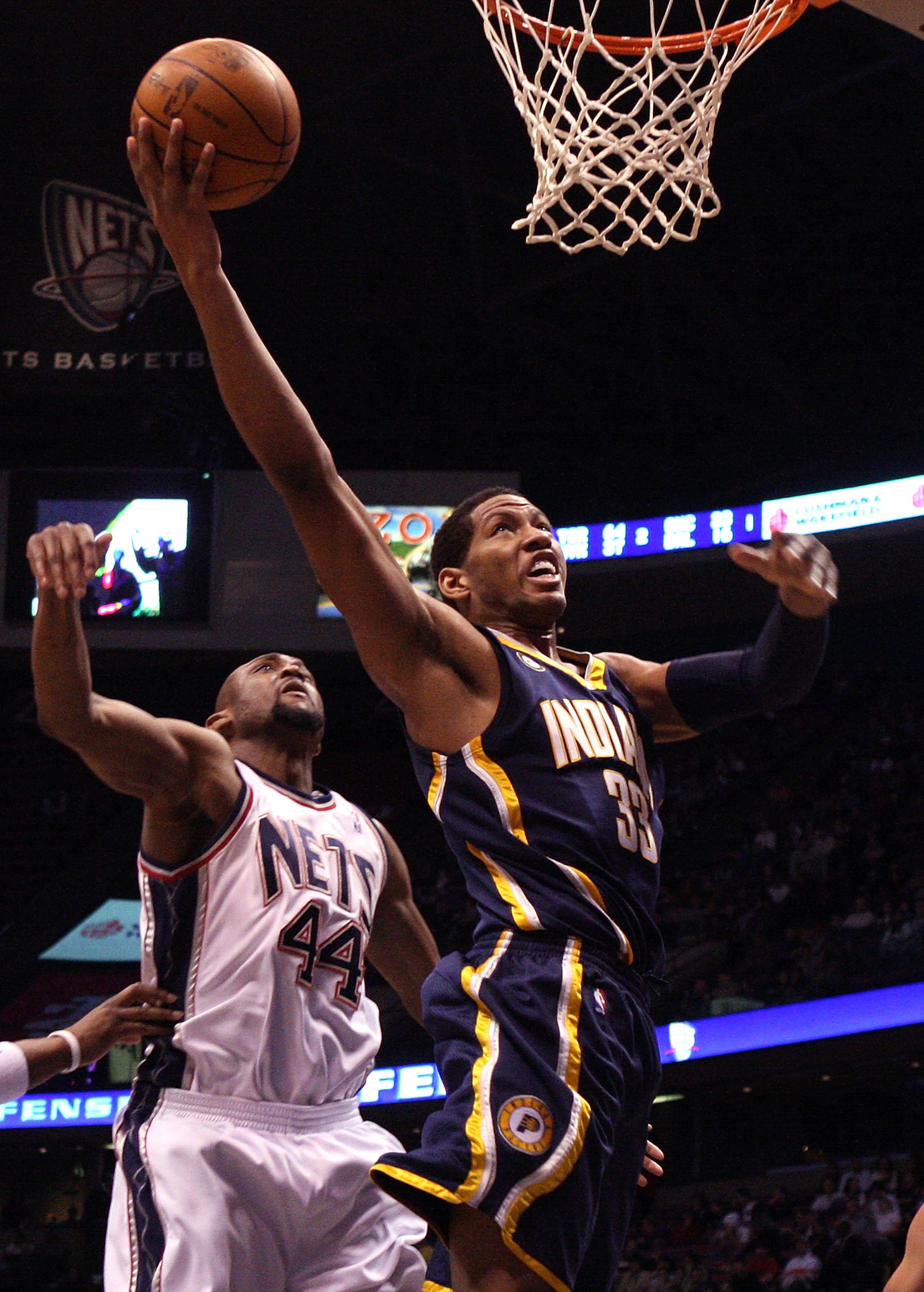 EAST RUTHERFORD, NJ - JANUARY 15:  Danny Granger #33 of the Indiana Pacers drives to the hoop for a basket against Trenton Hassell #44 of the New Jersey Nets at the Izod Center on January 15, 2010 in East Rutherford, New Jersey. NOTE TO USER: User express