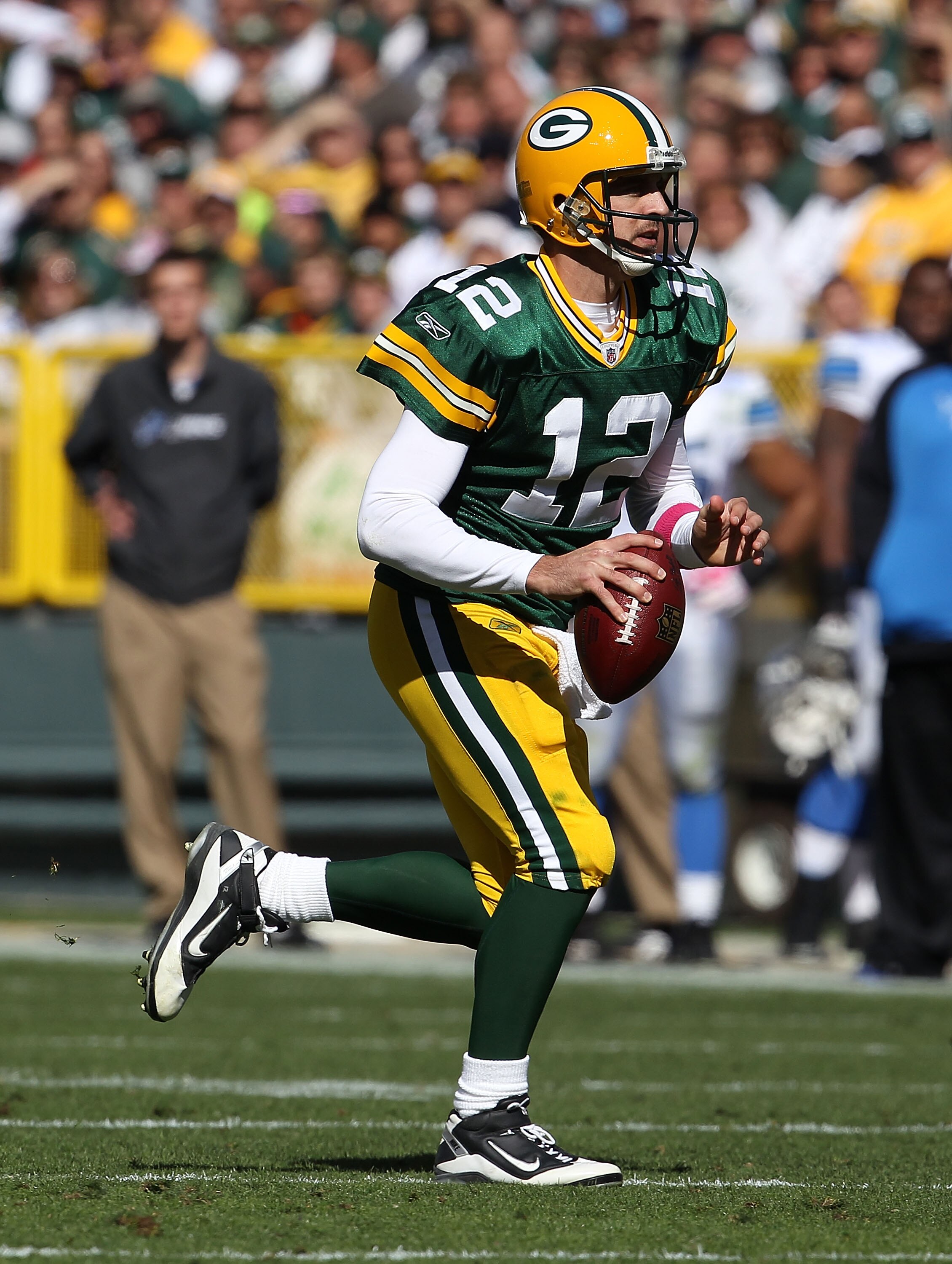 GREEN BAY, WI - OCTOBER 03: Aaron Rodgers #12 of the Green Bay Packers rolls out to look for a receiver against the Detroit Lions at Lambeau Field on October 3, 2010 in Green Bay, Wisconsin. The Packers defeated the Lions 28-26. (Photo by Jonathan Daniel/