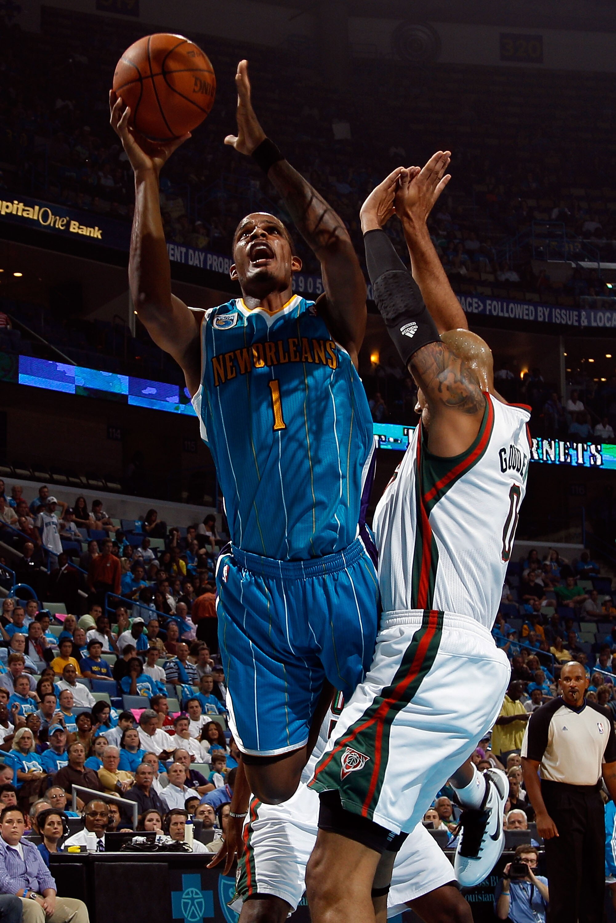 NEW ORLEANS - OCTOBER 27:  Trevor Ariza #1 of the New Orleans Hornets makes a layup over Drew Gooden #0 of the Milwaukee Bucks at the New Orleans Arena on October 27, 2010 in New Orleans, Louisiana.   The Hornets defeated the Bucks 95-91.   NOTE TO USER: