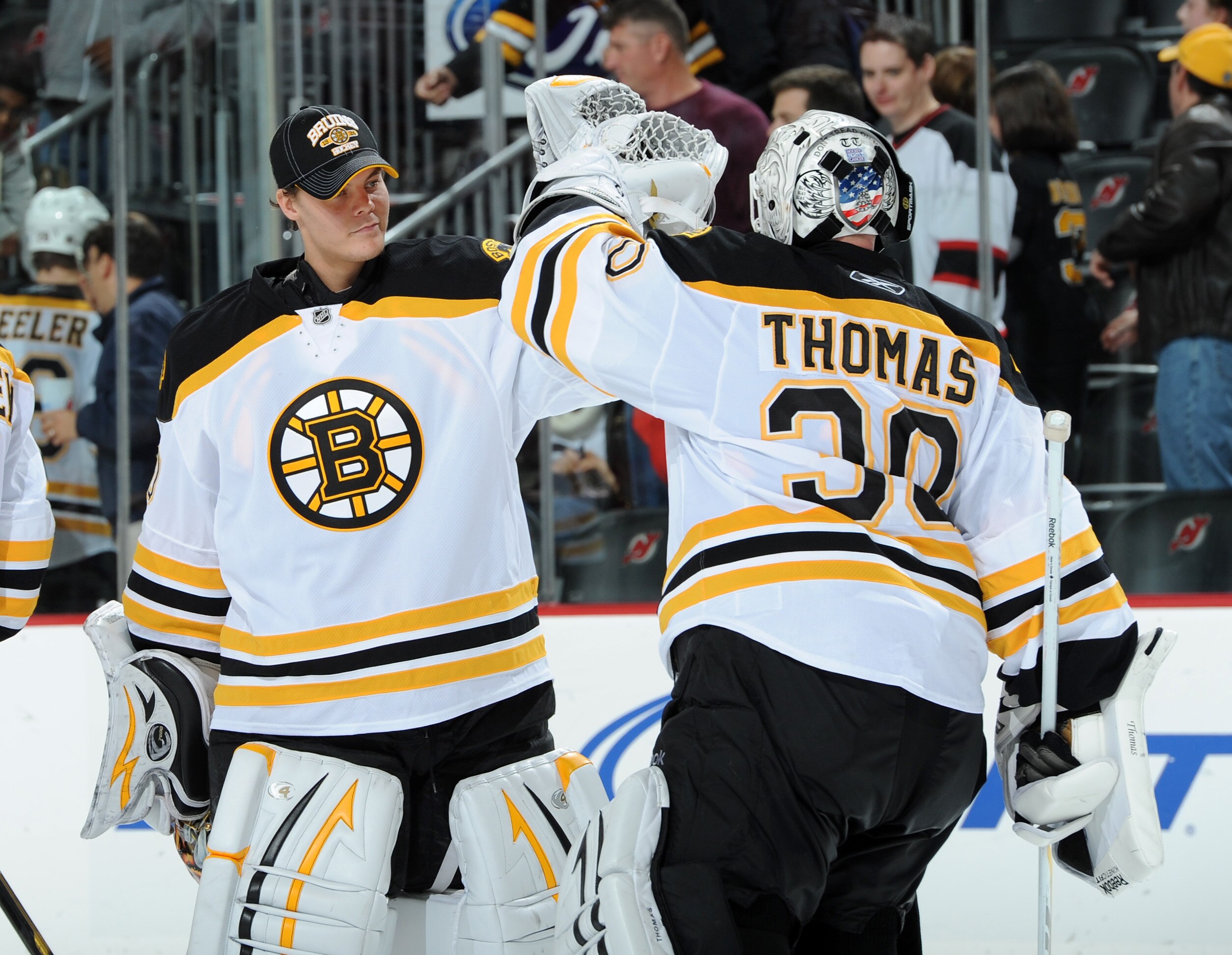 NEWARK, NJ - OCTOBER 16: Tim Thomas #30 of the Boston Bruins is congratulated by Tuukka Rask #40 of the Boston Bruins after the Boston Bruins defeated the New Jersey Devils 4-1 at the Prudential Center on October 16, 2010 in Newark, New Jersey. (Photo by 