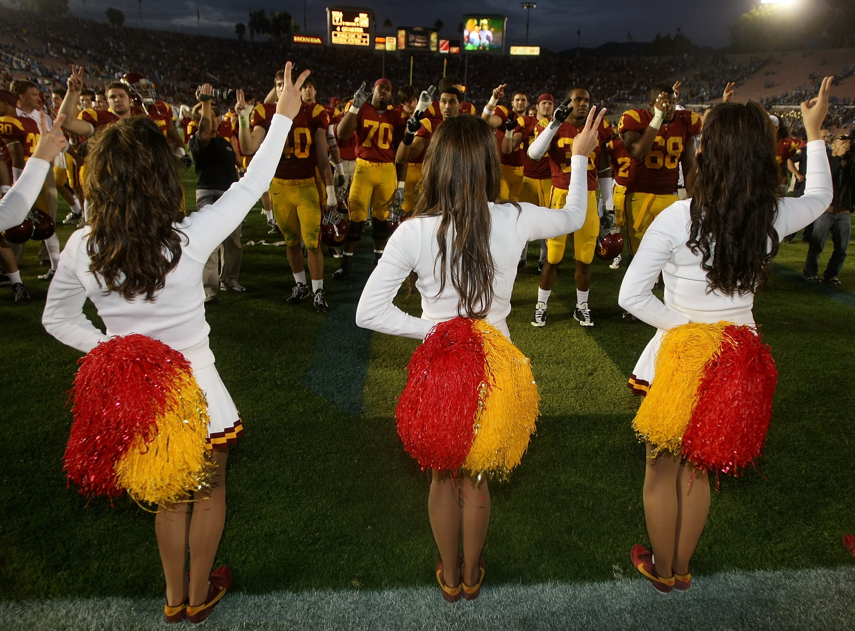 PASADENA, CA - DECEMBER 06:  The USC Trojan cheerleaders and football players sing the fight song after the Trojans' 28-7 victory over the UCLA Bruins on December 6, 2008 at the Rose Bowl in Pasadena, California.  (Photo by Stephen Dunn/Getty Images)