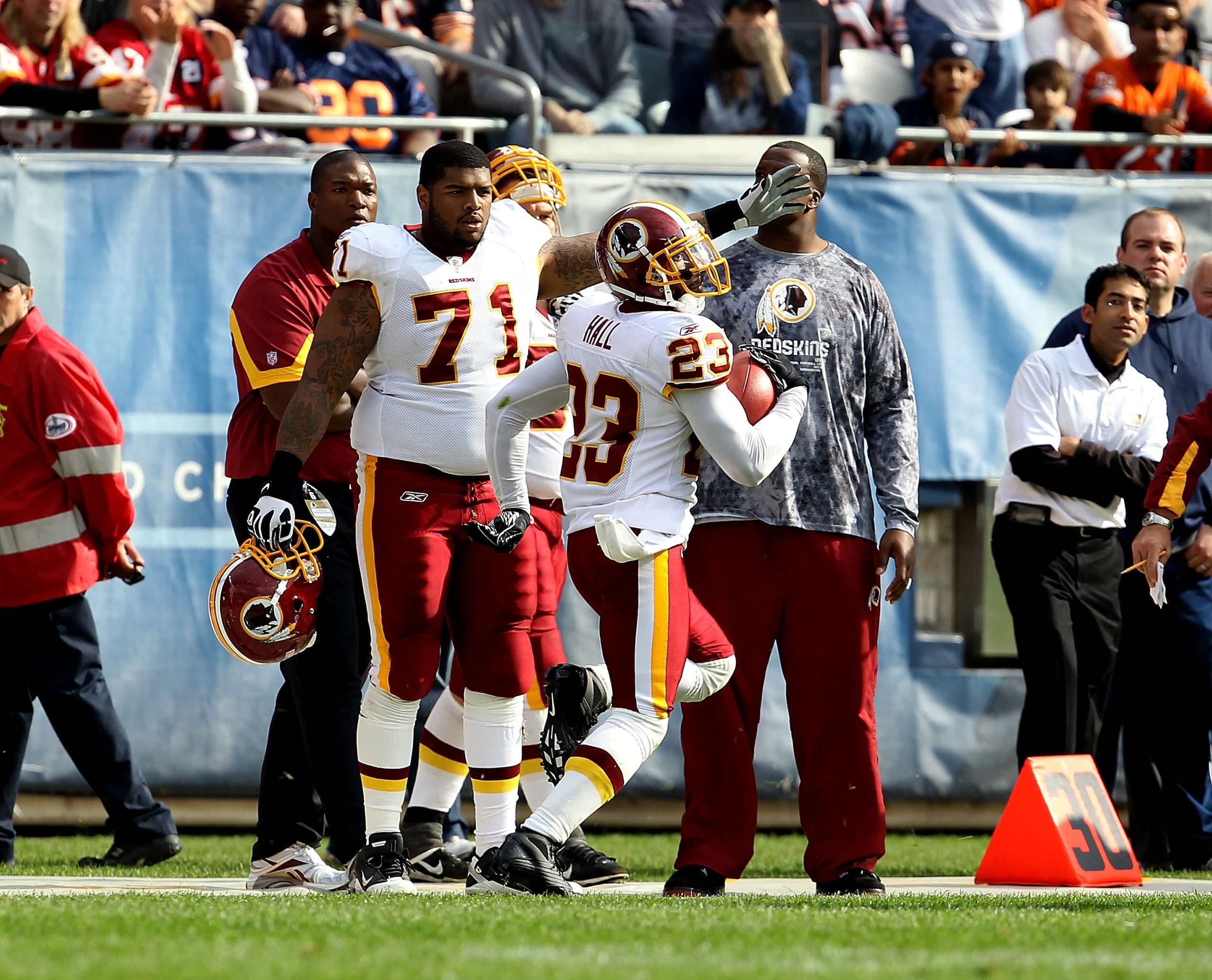 CHICAGO - OCTOBER 24: Trent Williams #71 of the Washington Redskins points to the end zone as teammate DeAngelo Hall #23 takes an interception in for a touchdown against the Chicago Bears at Soldier Field on October 24, 2010 in Chicago, Illinois. The Reds