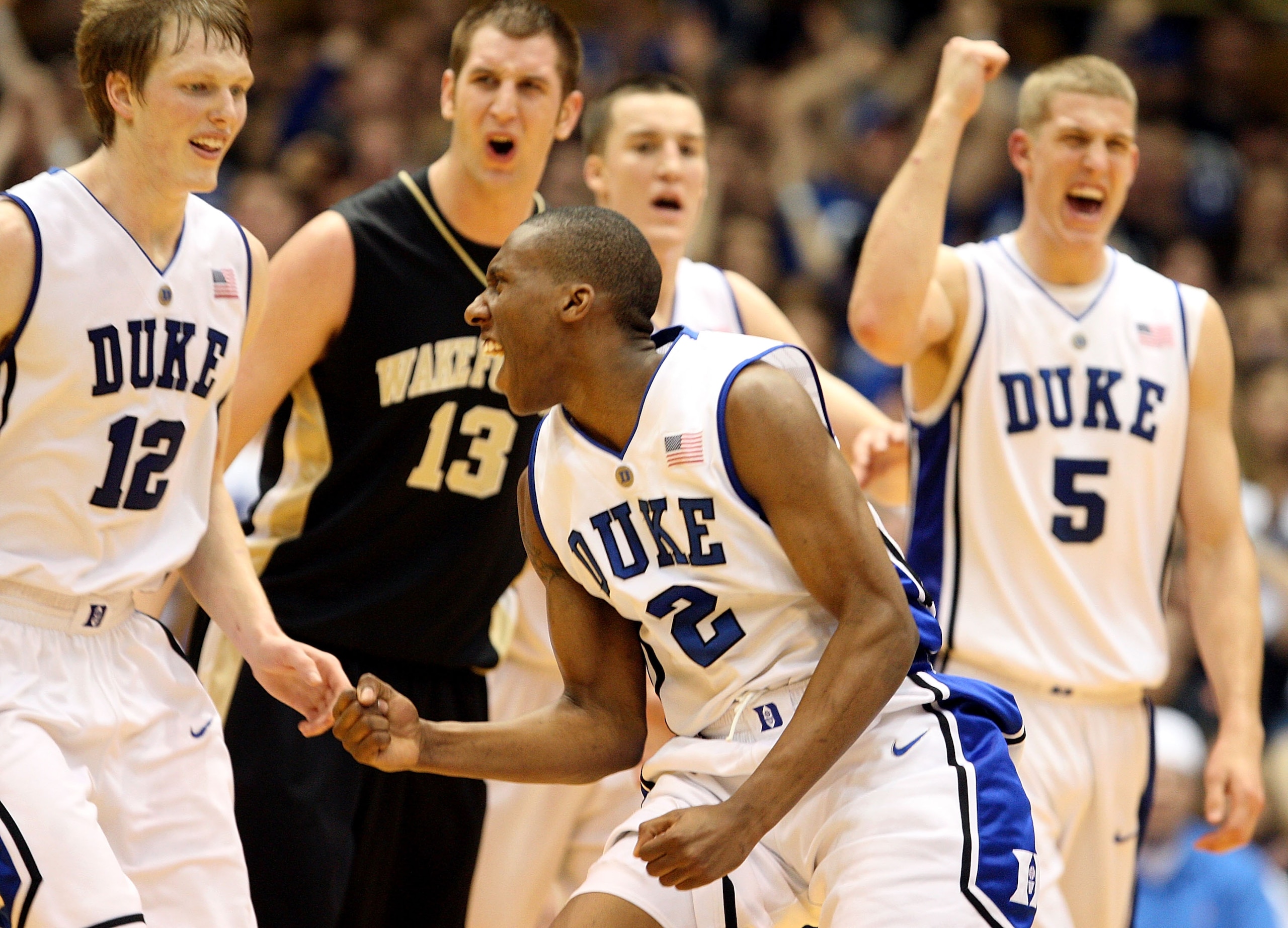 DURHAM, NC - JANUARY 17:  Chas McFarland #13 of the Wake Forest Demon Deacons watches as Nolan Smith #2 of the Duke Blue Devils celebrates with teammate Kyle Singler #12 after a play during their game on January 17, 2010 in Durham, North Carolina.  (Photo
