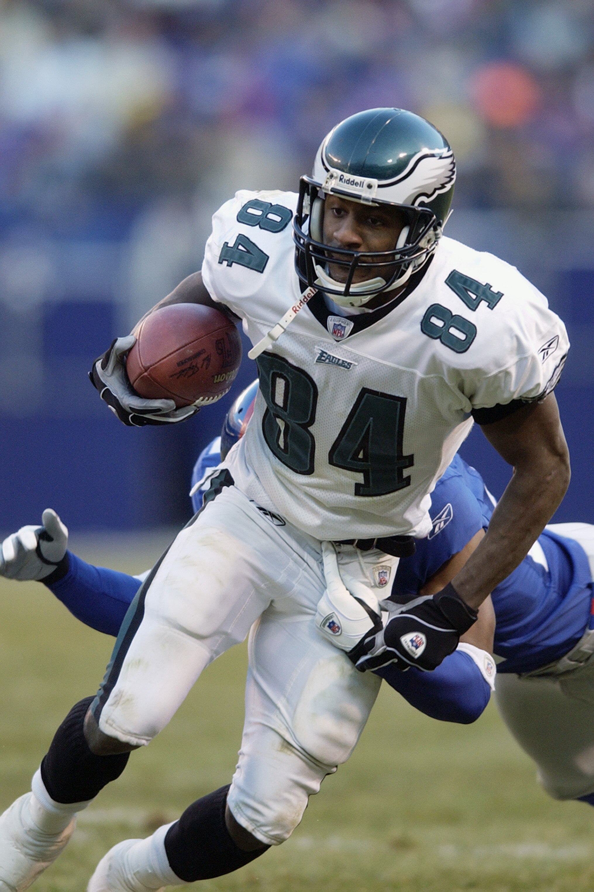 EAST RUTHERFORD, NJ - DECEMBER 28:  Wide receiver Freddie Mitchell #84 of the Philadelphia Eagles carries the ball against the New York Giants during the game at Giant Stadium on December 28, 2002 in East Rutherford, New Jersey. The Giants defeated the Ea