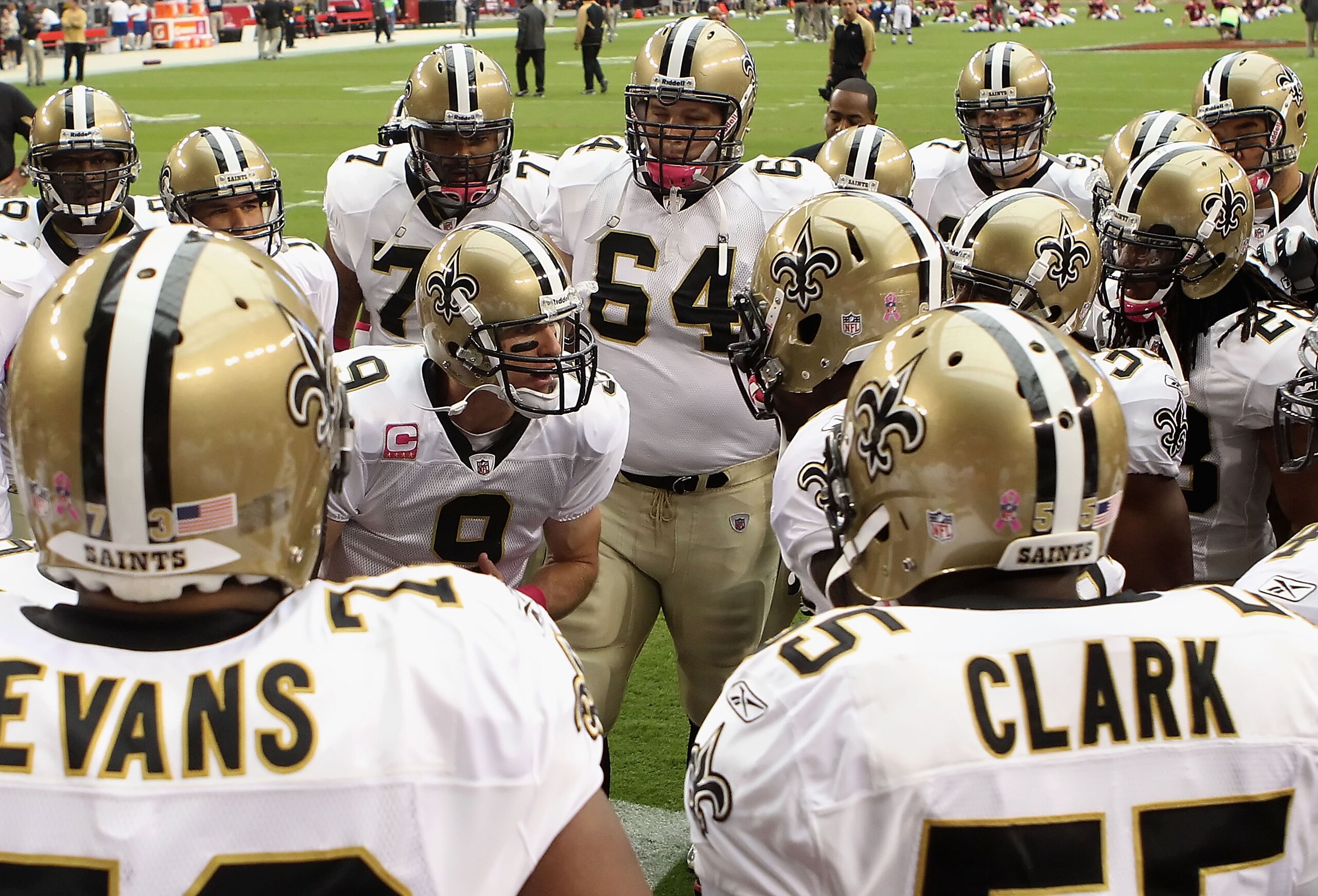 GLENDALE, AZ - OCTOBER 10: Quarterback Drew Brees #9 of the New Orleans Saints talks with teammates in a huddle prior to the NFL game against the Arizona Cardinals at the University of Phoenix Stadium on October 10, 2010 in Glendale, Arizona. The Cardina GLENDALE, AZ - OCTOBER 10: Quarterback Drew Brees #9 of the New Orleans Saints talks with teammates in a huddle prior to the NFL game against the Arizona Cardinals at the University of Phoenix Stadium on October 10, 2010 in Glendale, Arizona. The Cardina