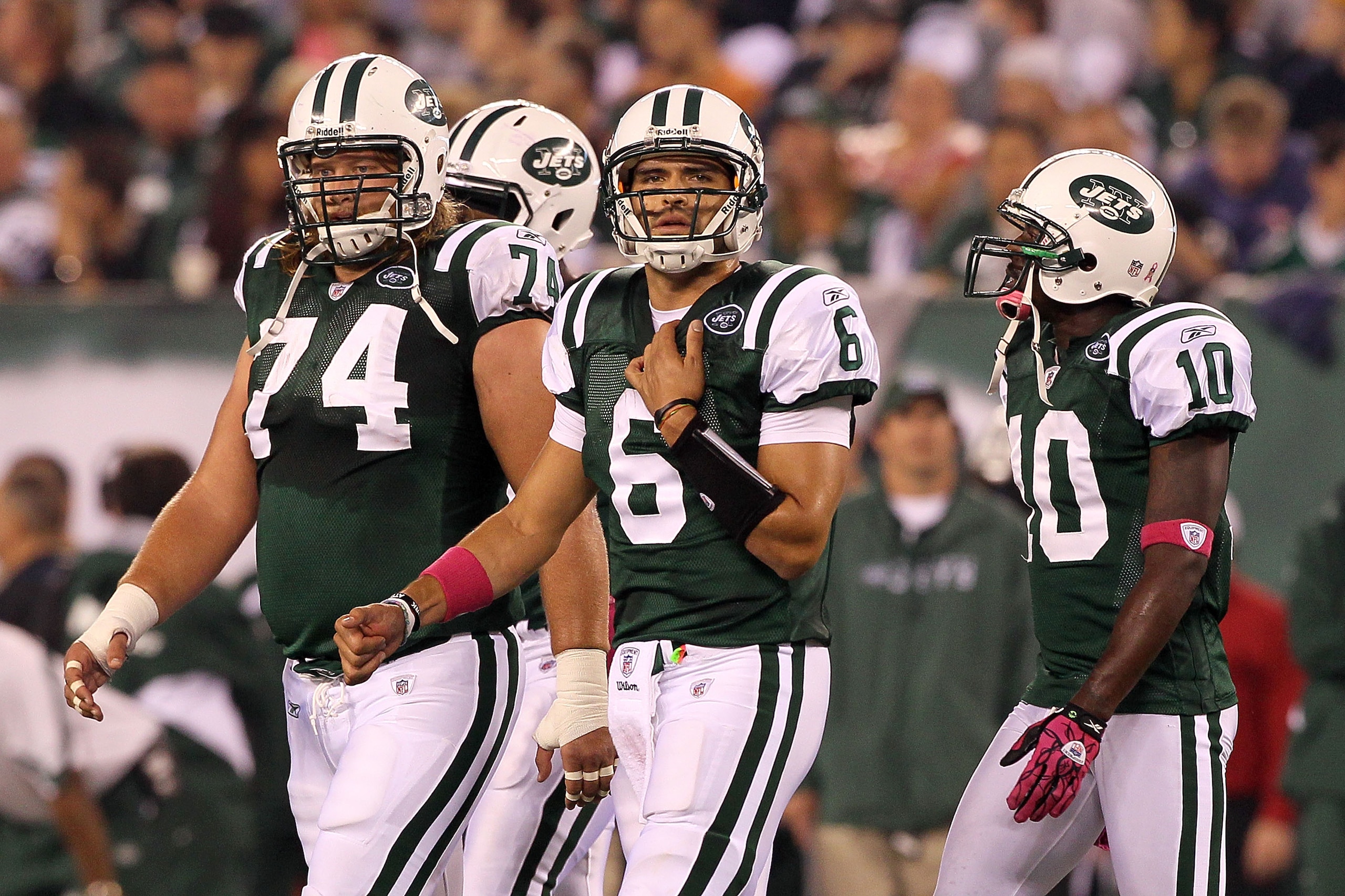 EAST RUTHERFORD, NJ - OCTOBER 11: (L-R) Nick Mangold #74, Mark Sanchez #6 and Santonio Holmes #10 of the New York Jets walk on the field against the Minnesota Vikings at New Meadowlands Stadium on October 11, 2010 in East Rutherford, New Jersey. The Jets EAST RUTHERFORD, NJ - OCTOBER 11: (L-R) Nick Mangold #74, Mark Sanchez #6 and Santonio Holmes #10 of the New York Jets walk on the field against the Minnesota Vikings at New Meadowlands Stadium on October 11, 2010 in East Rutherford, New Jersey. The Jets