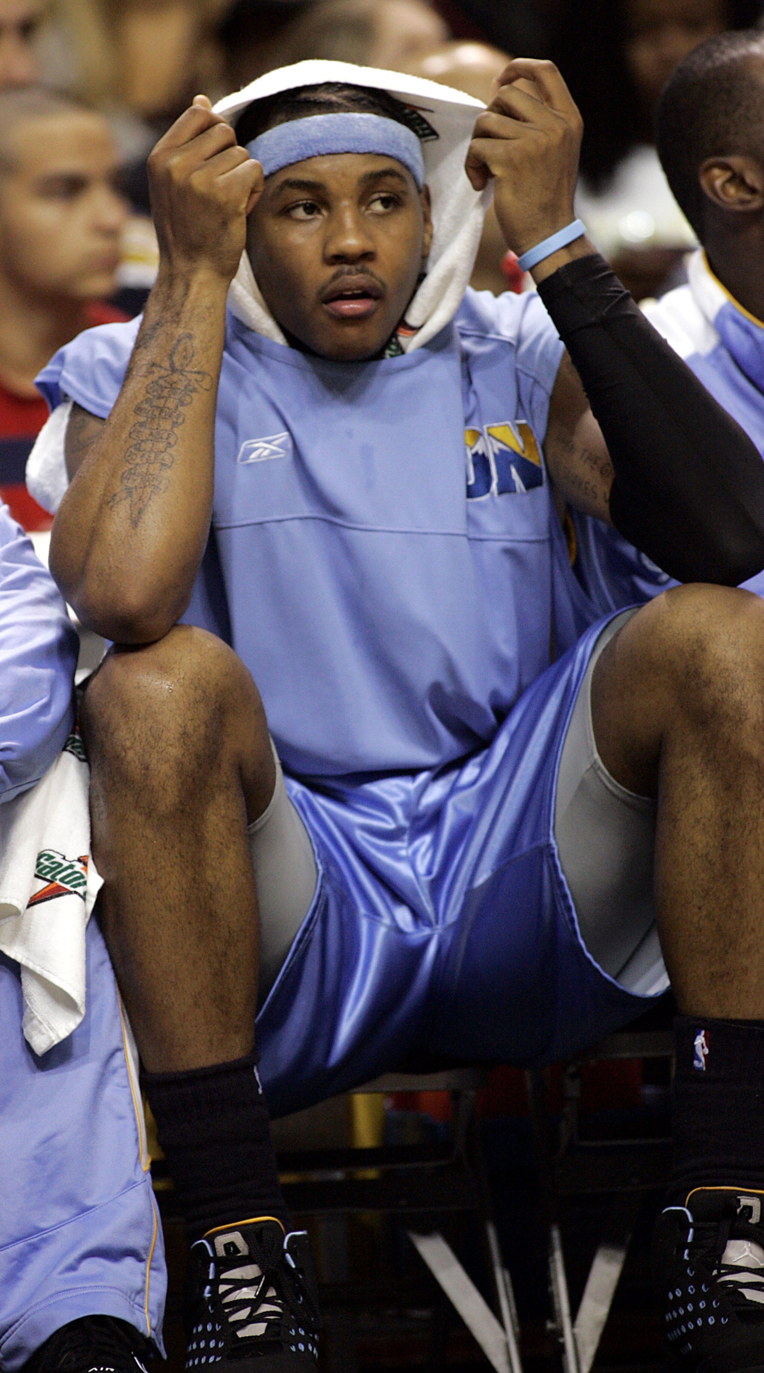 MIAMI - DECEMBER 9:  Forward Carmelo Anthony #15 of the Denver Nuggets takes a break on the bench during a game against the Miami Heat on December 9, 2005 at the American Airlines Arena in Miami, Florida. NOTE TO USER: User expressly acknowledges and agre