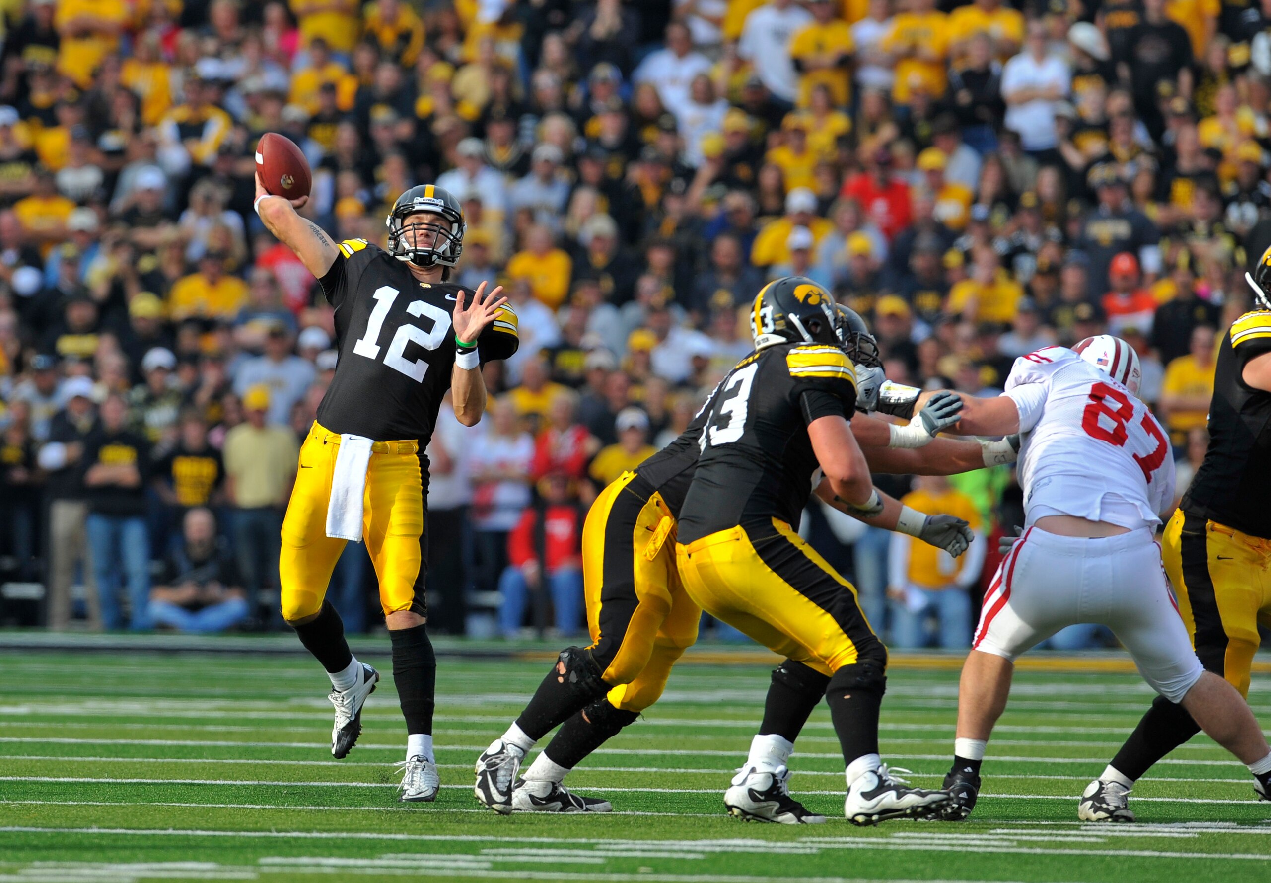 IOWA CITY, IA - OCTOBER 23- Quarterback Ricky Stanzi #12 of the University of Iowa Hawkeyes throws under pressure from the Wisconsin Badgers during the second half of play at Kinnick Stadium on October 23, 2010 in Iowa City, Iowa. Wisconsin won 31-30 over