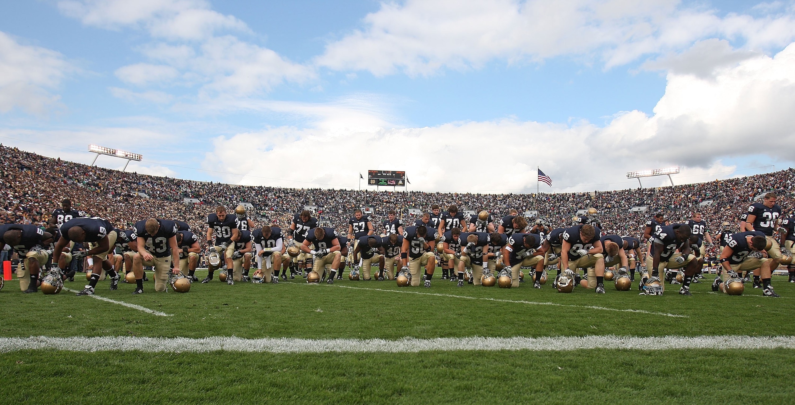 SOUTH BEND, IN - OCTOBER 03: Members of the Notre Dame Fighting Irish pray near the end zone before a game against the Washington Huskies on October 3, 2009 at Notre Dame Stadium in South Bend, Indiana. Notre Dame defeated Washington 37-30 in overtime. (P