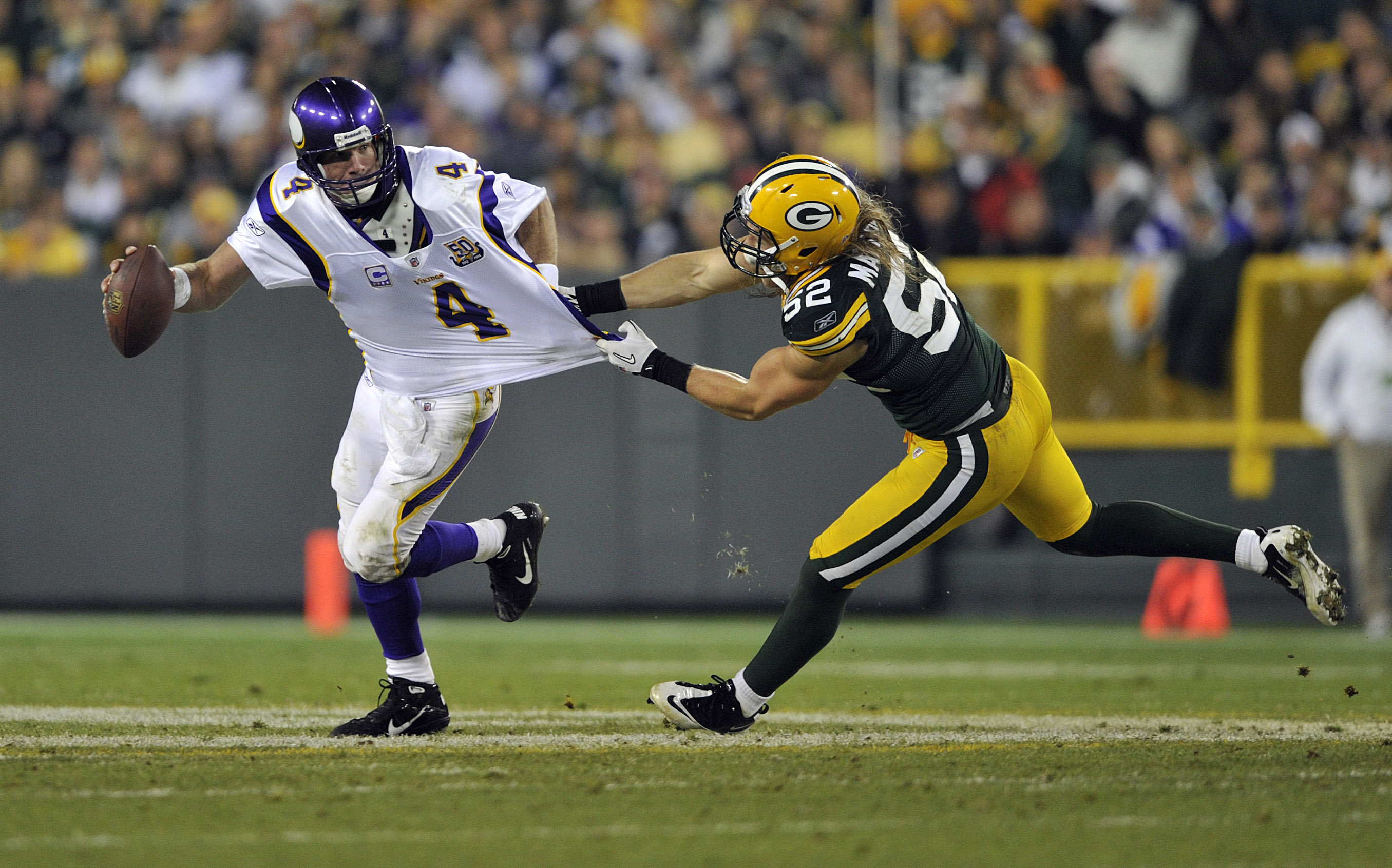 GREEN BAY, WI - OCTOBER 24: Brett Favre #4 of the Minnesota Vikings has his jersey grabbed by Clay Matthews #52 of the Green Bay Packers at Lambeau Field on October 24, 2010 in Green Bay, Wisconsin. (Photo by Jim Prisching/Getty Images) GREEN BAY, WI - OCTOBER 24: Brett Favre #4 of the Minnesota Vikings has his jersey grabbed by Clay Matthews #52 of the Green Bay Packers at Lambeau Field on October 24, 2010 in Green Bay, Wisconsin. (Photo by Jim Prisching/Getty Images)