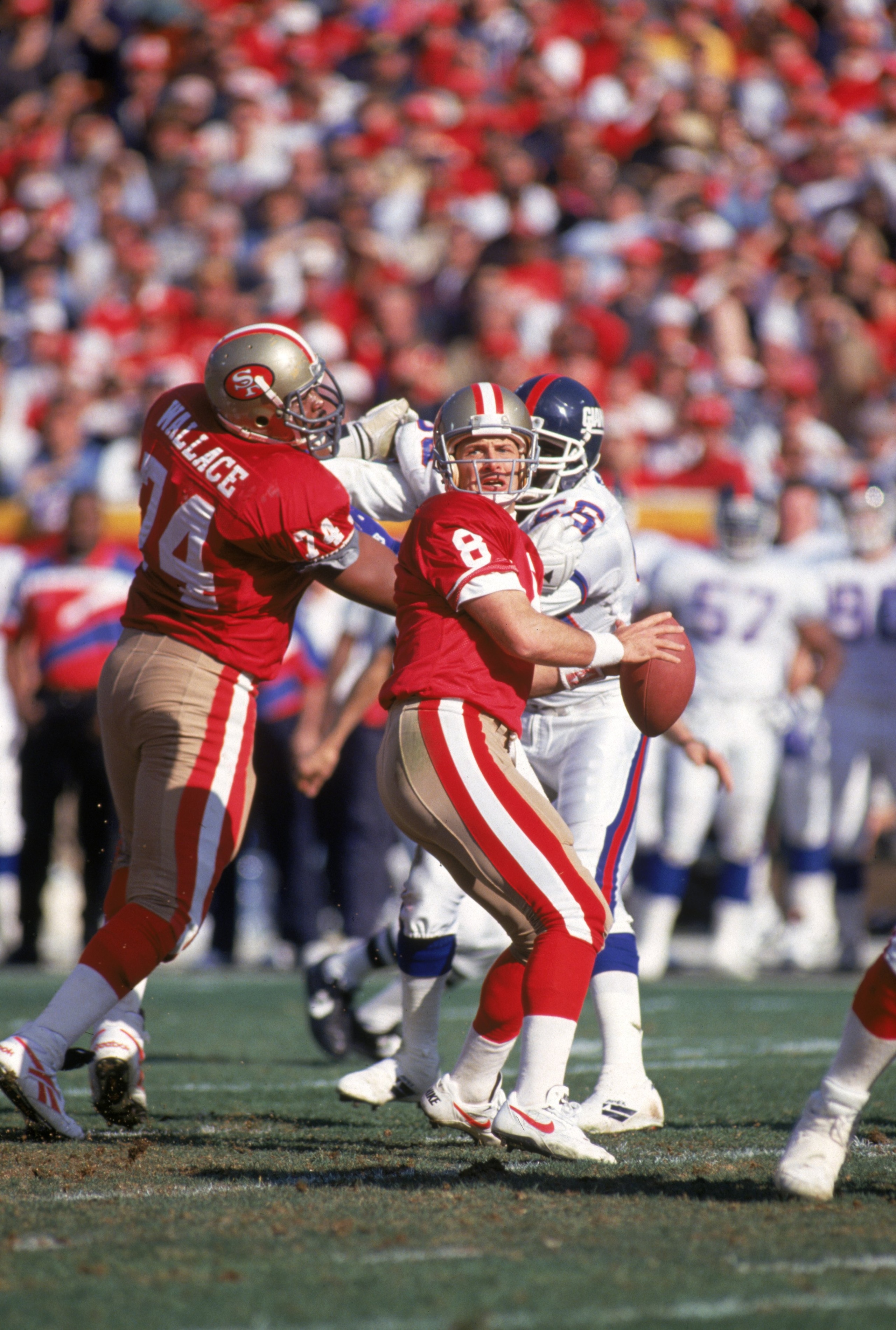 SAN FRANCISCO - JANUARY 15:  Quarterback Steve Young #8 of the San Francisco 49ers drops back to pass during the 1993 NFC Divisional Playoff game against the New York Giants at Candlestick Park on January 15, 1994 in San Francisco, California.  The 49ers