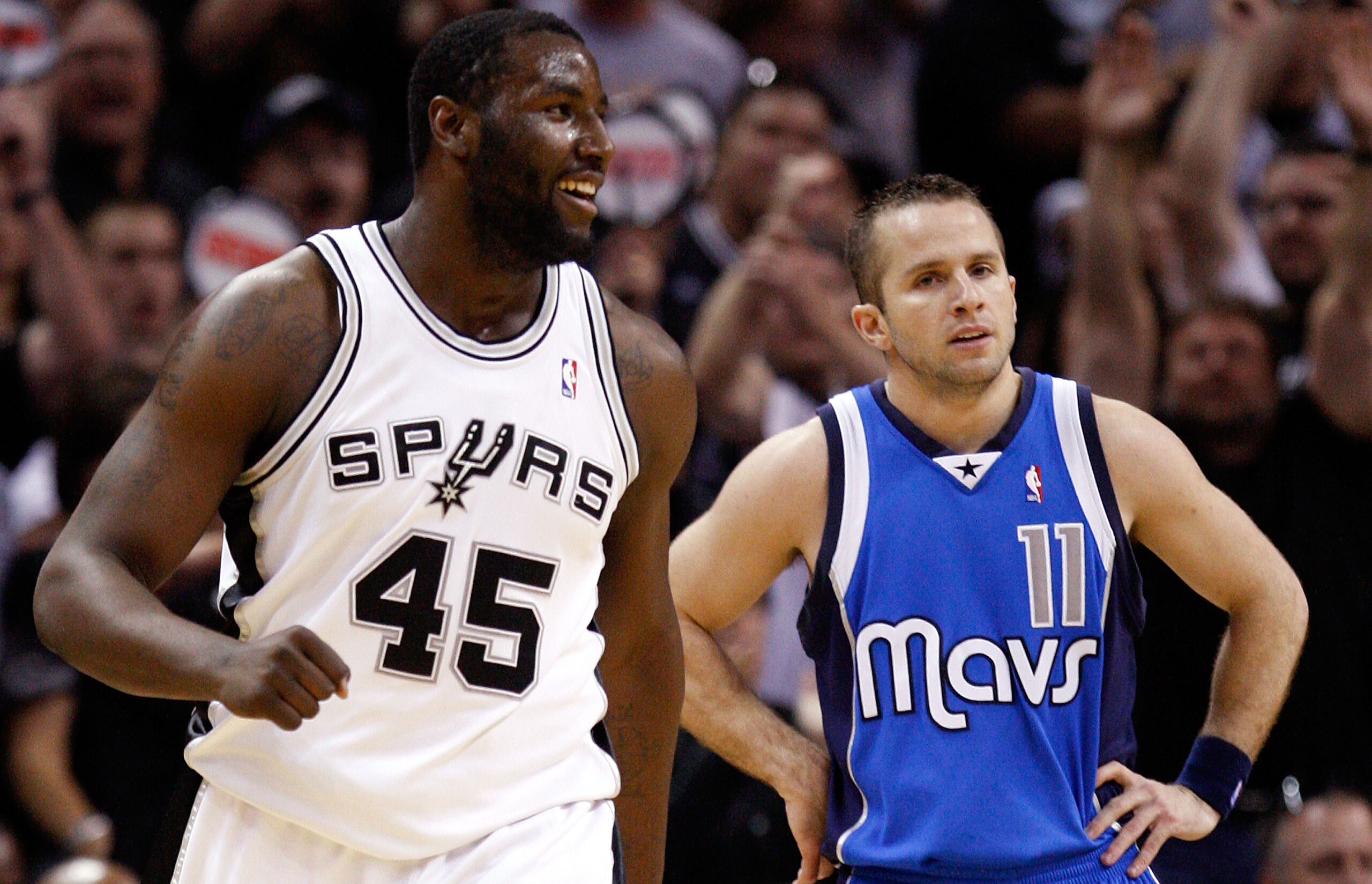 SAN ANTONIO - APRIL 25:  Center DeJuan Blair #45 of the San Antonio Spurs reacts in front of Jose Juan Barea #11 of the Dallas Mavericks in Game Four of the Western Conference Quarterfinals during the 2010 NBA Playoffs at AT&T Center on April 25, 2010 in