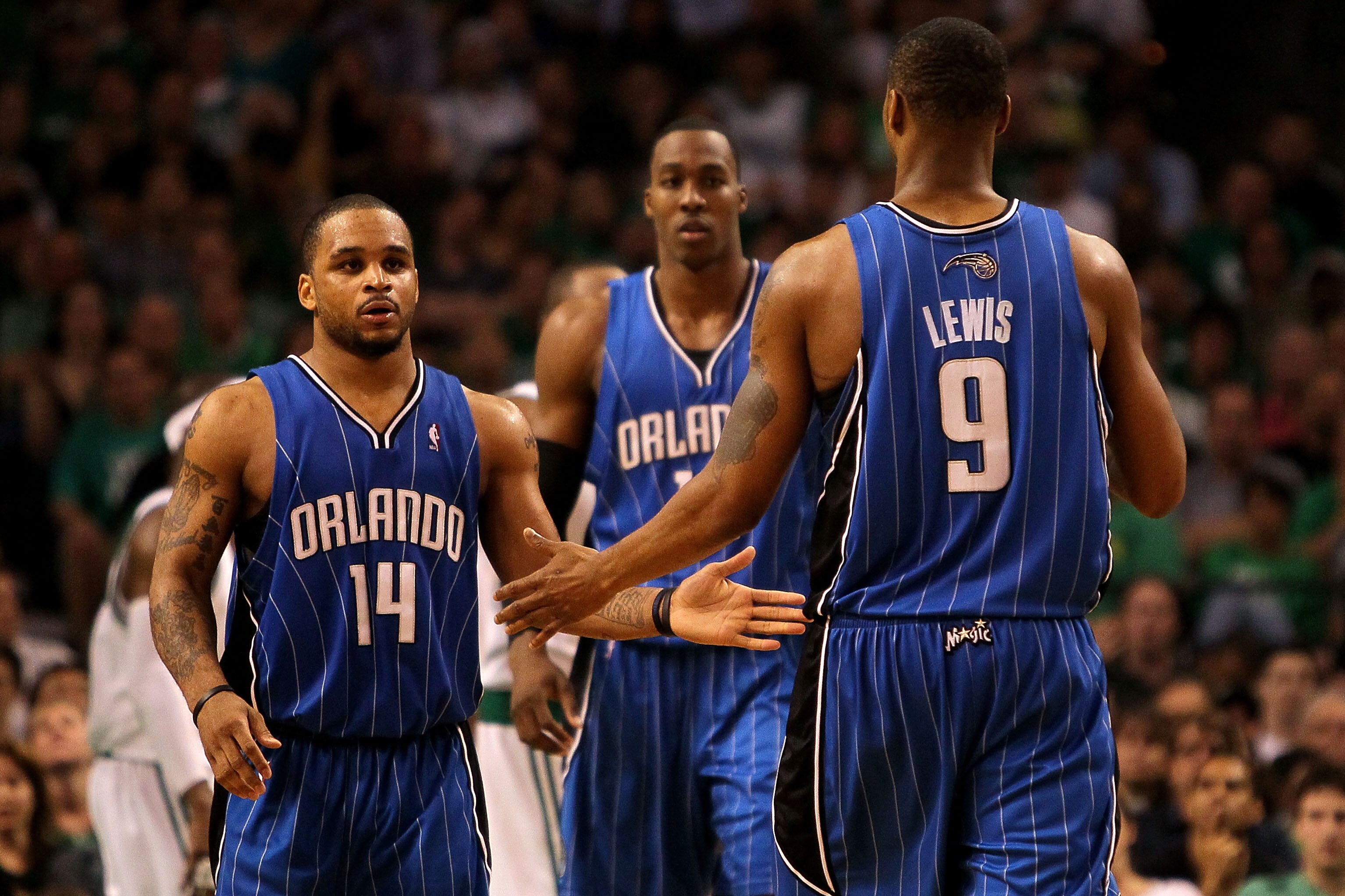 BOSTON - MAY 24:  (L-R) Jameer Nelson #14, Dwight Howard #12 and Rashard Lewis #9 of the Orlando Magic react after a basket against the Boston Celtics in Game Four of the Eastern Conference Finals during the 2010 NBA Playoffs at TD Banknorth Garden on May