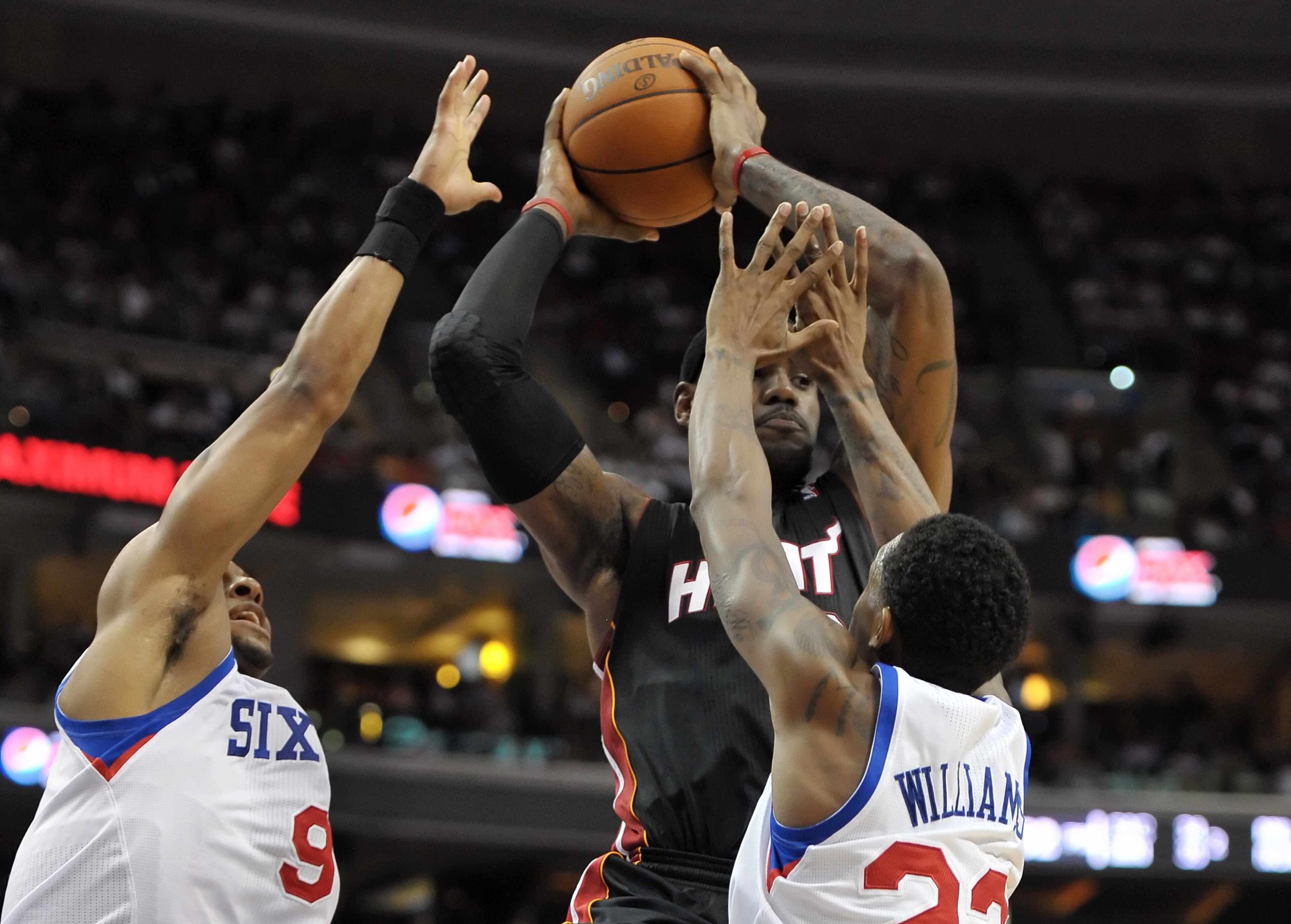 PHILADELPHIA - OCTOBER 27:  LeBron James #6 of the Miami Heat tries to pass the ball through Andre Iguodala #9 and Lou Williams #23 of the Philadelphia 76ers at the Wells Fargo Center on October 27, 2010 in Philadelphia, Pennsylvania. NOTE TO USER: User e