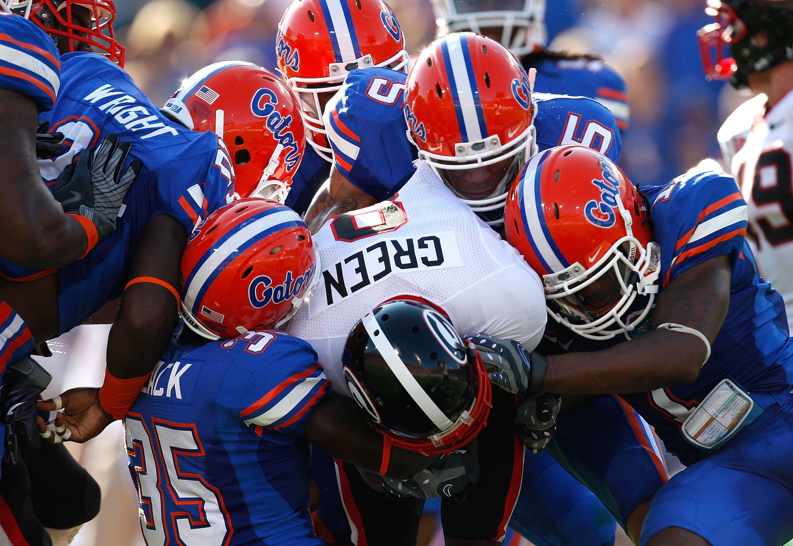 JACKSONVILLE, FL - OCTOBER 31: The Florida Gators defense tackles A.J. Green #8 of the Georgia Bulldogs at Jacksonville Municipal Stadium on October 31, 2009 in Jacksonville, Florida. (Photo by Kevin C. Cox/Getty Images) JACKSONVILLE, FL - OCTOBER 31: The Florida Gators defense tackles A.J. Green #8 of the Georgia Bulldogs at Jacksonville Municipal Stadium on October 31, 2009 in Jacksonville, Florida. (Photo by Kevin C. Cox/Getty Images)