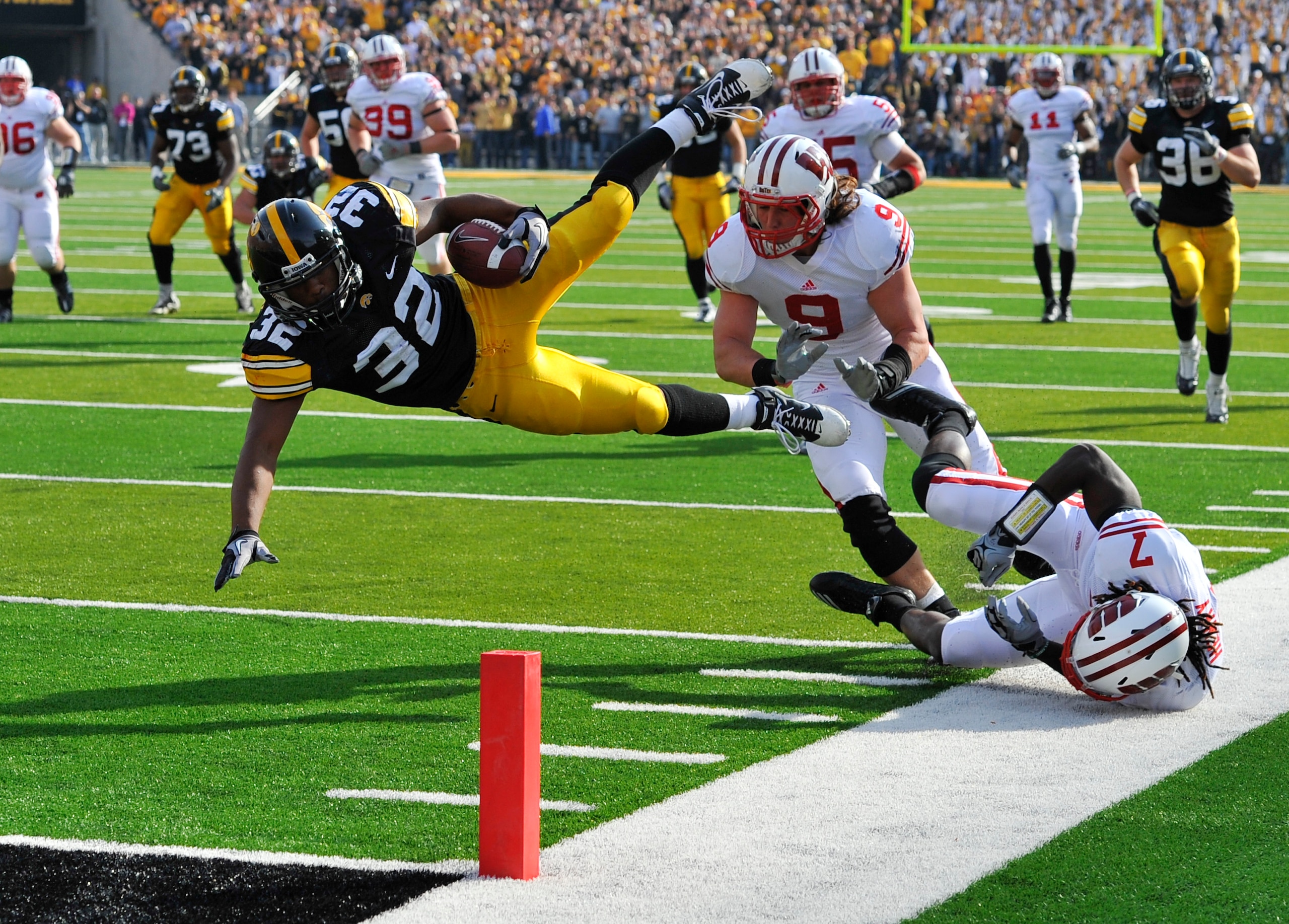 IOWA CITY, IA - OCTOBER 23- Running back Adam Robinson #32 of the University of Iowa Hawkeyes is knocked down at the one yard line by line backer Blake Sorensen #9 of the Wisconsin Badgers during the first half of play at Kinnick Stadium on October 23, 20