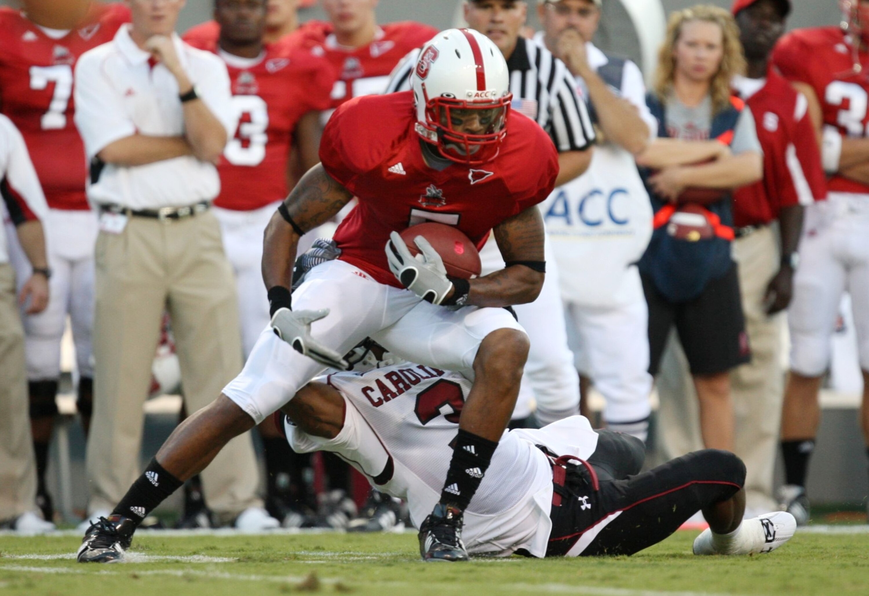 RALEIGH, NC - SEPTEMBER 3:  Wide receiver Jarvis Williams #5 of the North Carolina State Wolfpack breaks a tackle against Akeem Auguste #3 of the South Carolina Gamecocks during the game at Carter-Finley Stadium on September 3, 2009 in Raleigh, North Caro
