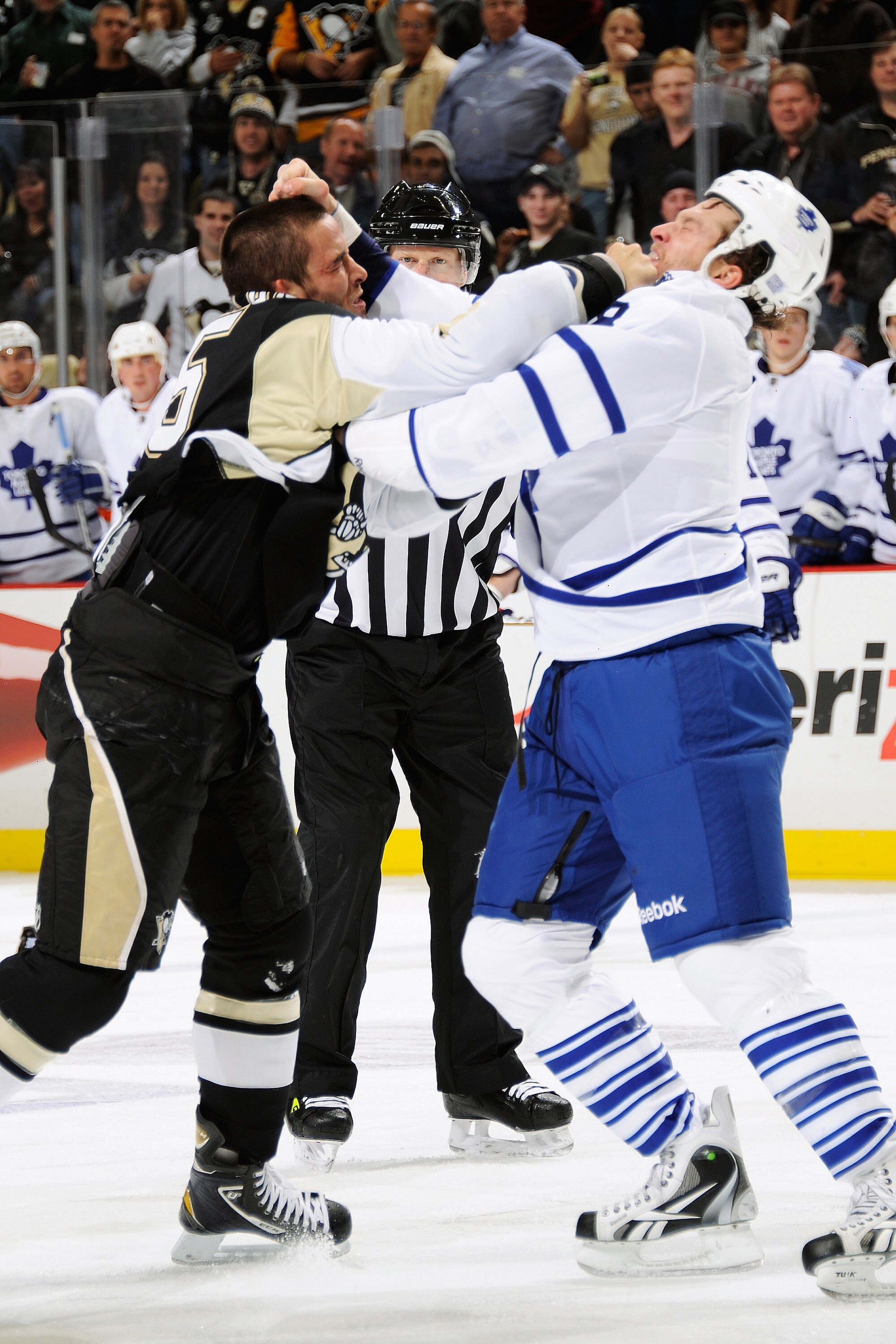 PITTSBURGH - OCTOBER 13:  Deryk Engelland #5 of the Pittsburgh Penguins and Colton Orr #28 of the Toronto Maple Leafs exchange punches during a first period fight that resulted in Orr leaving the game on October 13, 2010 at Consol Energy Center in Pittsbu