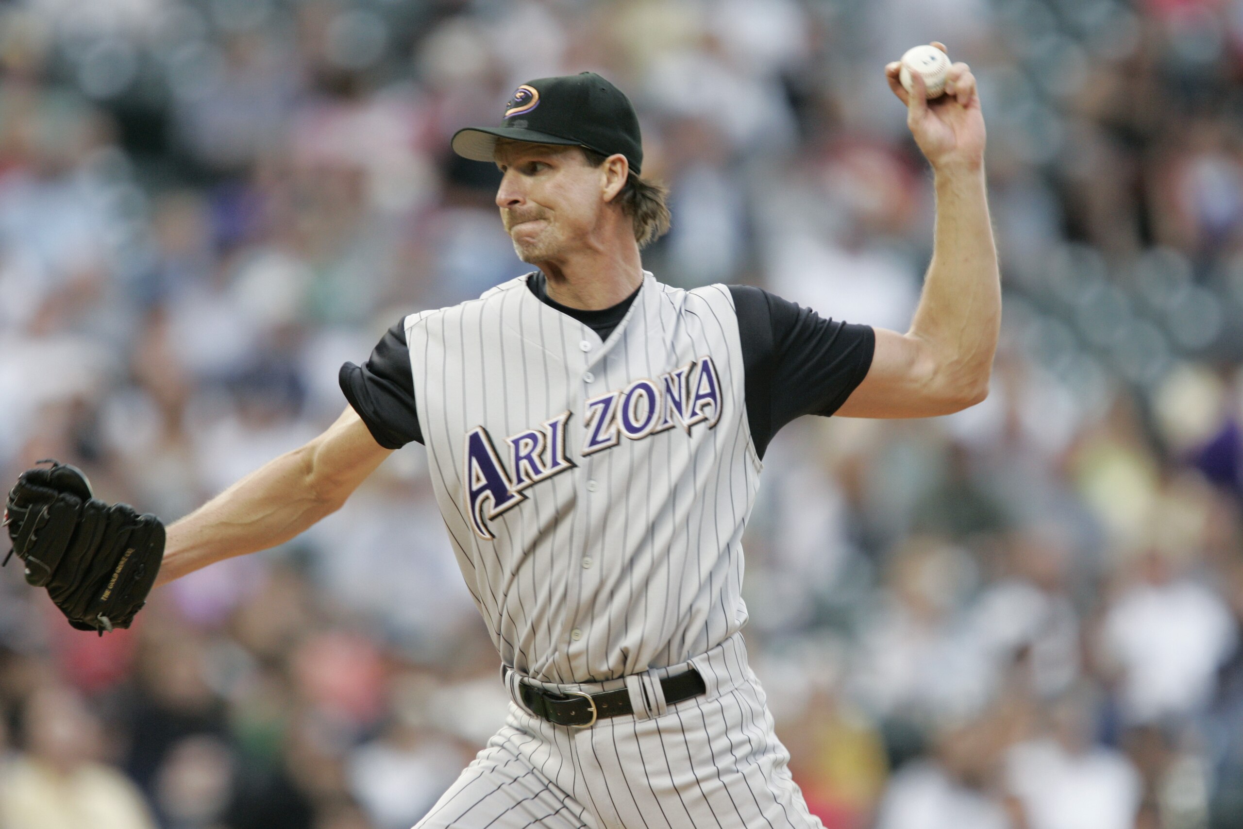 DENVER - JULY 30:  Randy Johnson #51 of the Arizona Diamondbacks throws against the Colorado Rockies on July 30, 2004 at Coors Field in Denver, Colorado.  The Rockies defeated the Diamondbacks 4-1.  (Photo by Brian Bahr/Getty Images)
