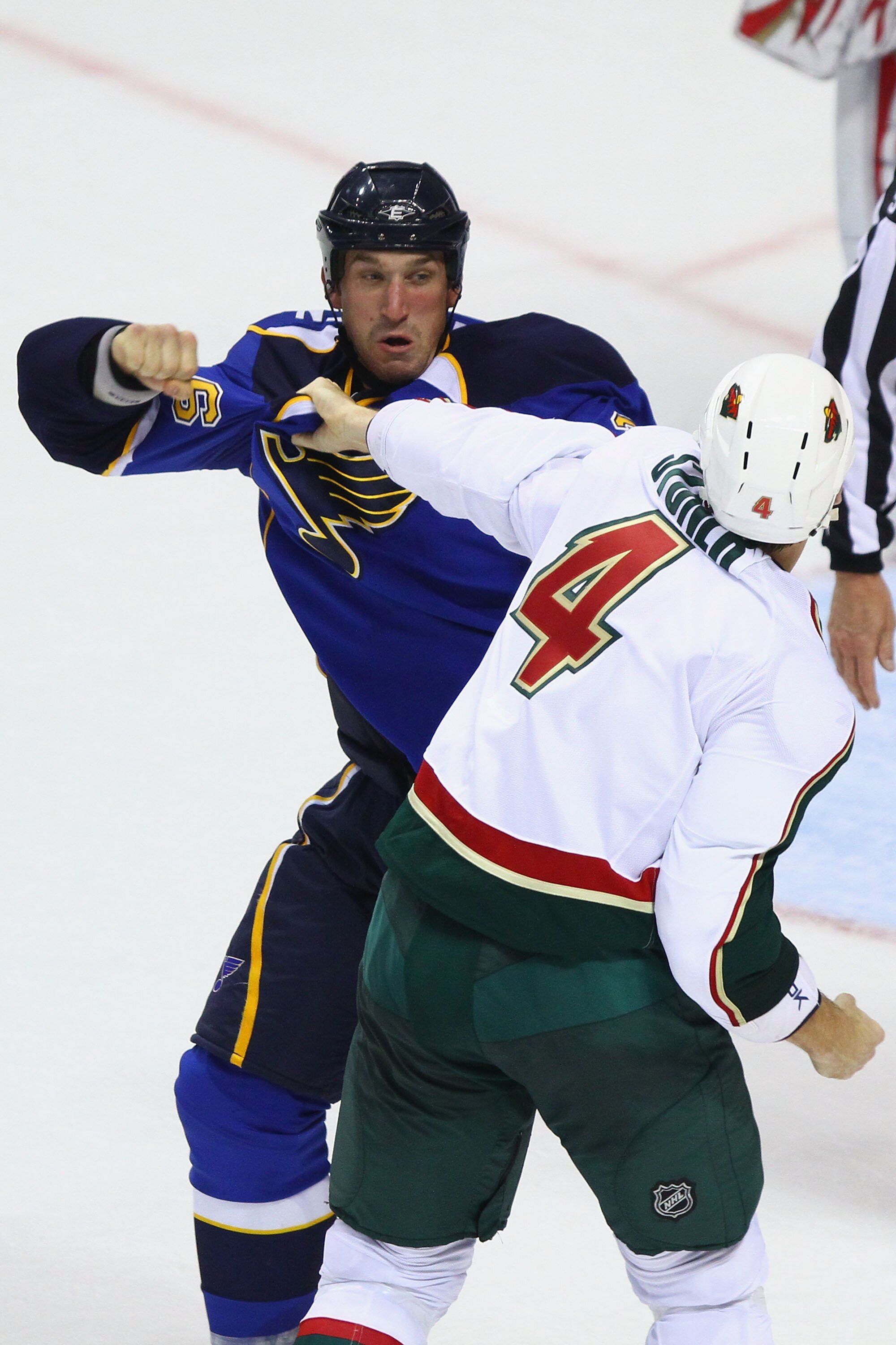 ST. LOUIS - SEPTEMBER 24: B.J. Crombeen #26 of the St. Louis Blues fights Clayton Stoner #4 of the Minnesota Wild during a pre-season game at the Scottrade Center on September 24, 2010 in St. Louis, Missouri.  (Photo by Dilip Vishwanat/Getty Images)