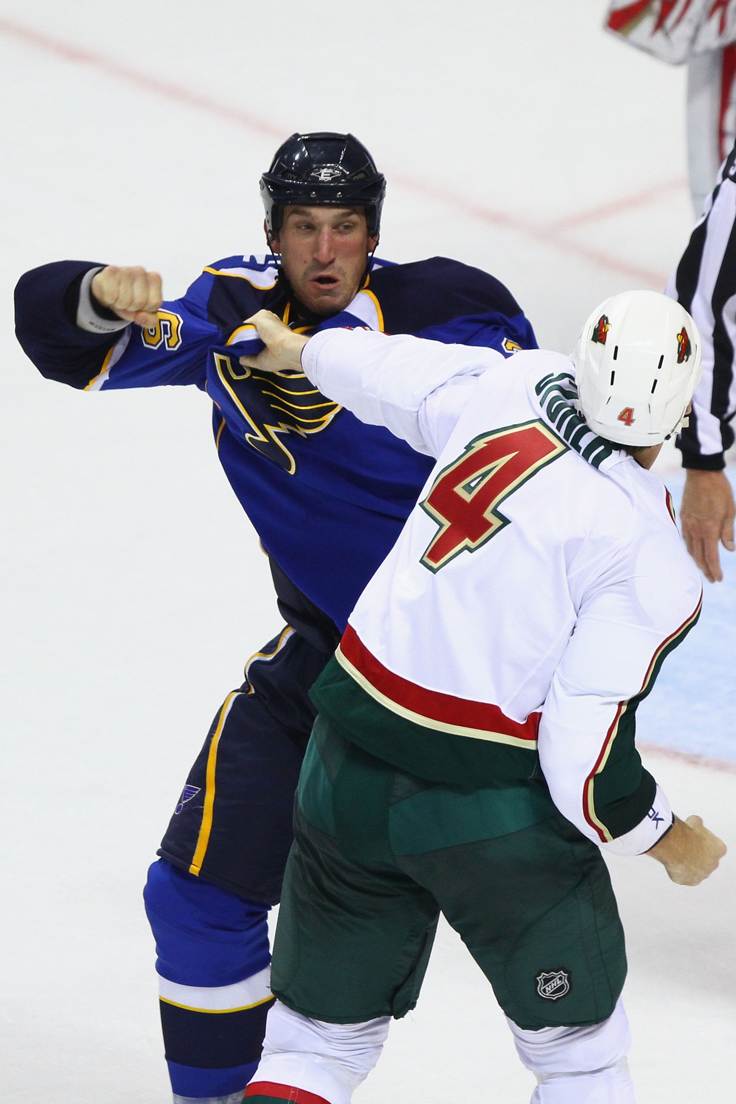 ST. LOUIS - SEPTEMBER 24: B.J. Crombeen #26 of the St. Louis Blues fights Clayton Stoner #4 of the Minnesota Wild during a pre-season game at the Scottrade Center on September 24, 2010 in St. Louis, Missouri.  (Photo by Dilip Vishwanat/Getty Images)