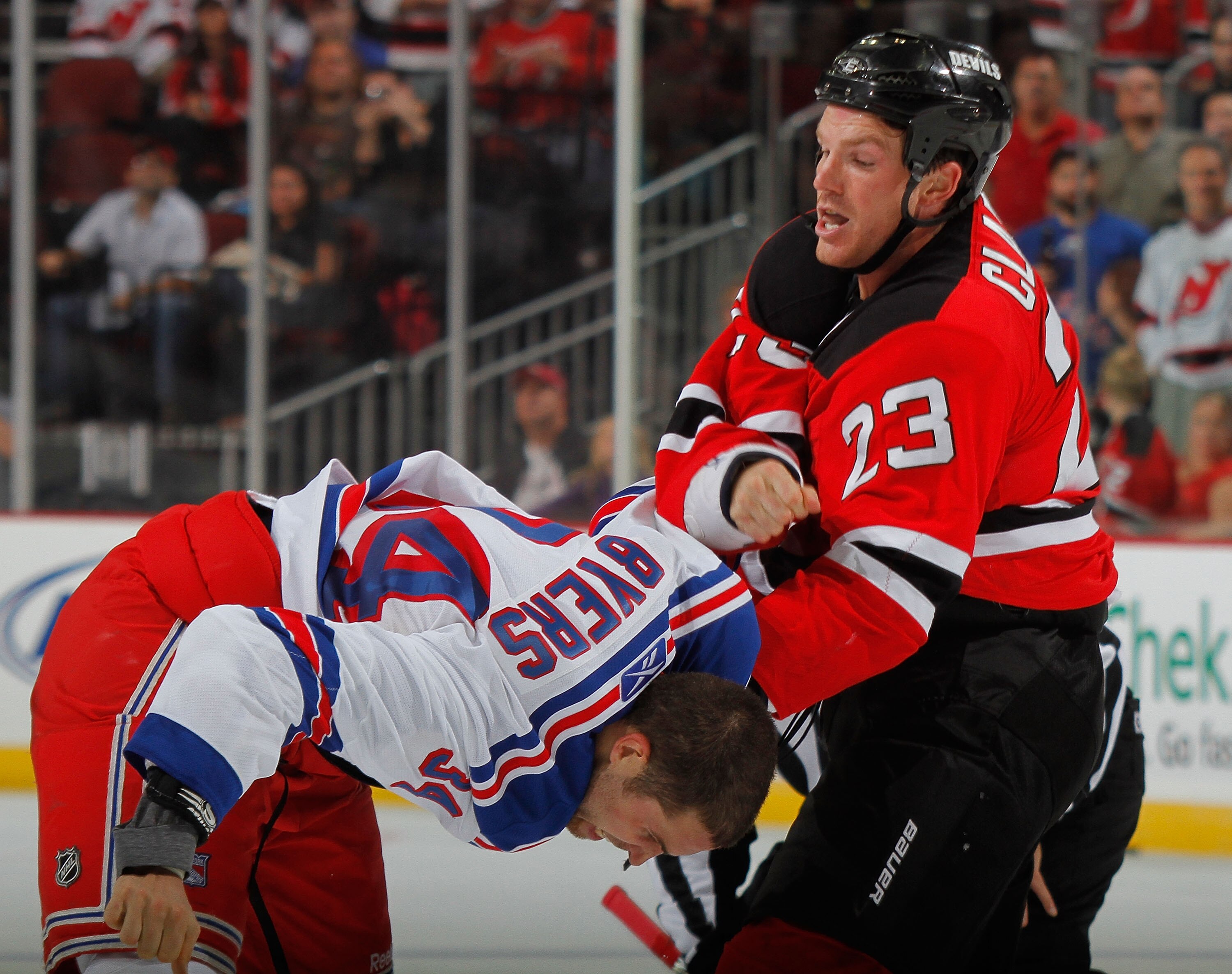 NEWARK, NJ - SEPTEMBER 25: Dane Byers #34 of the New York Rangers and David Clarkson #23 of the New Jersey Devils fight in the third period of a preseason hockey game at Prudential Center on September 25, 2010 in Newark, New Jersey.  (Photo by Paul Beresw