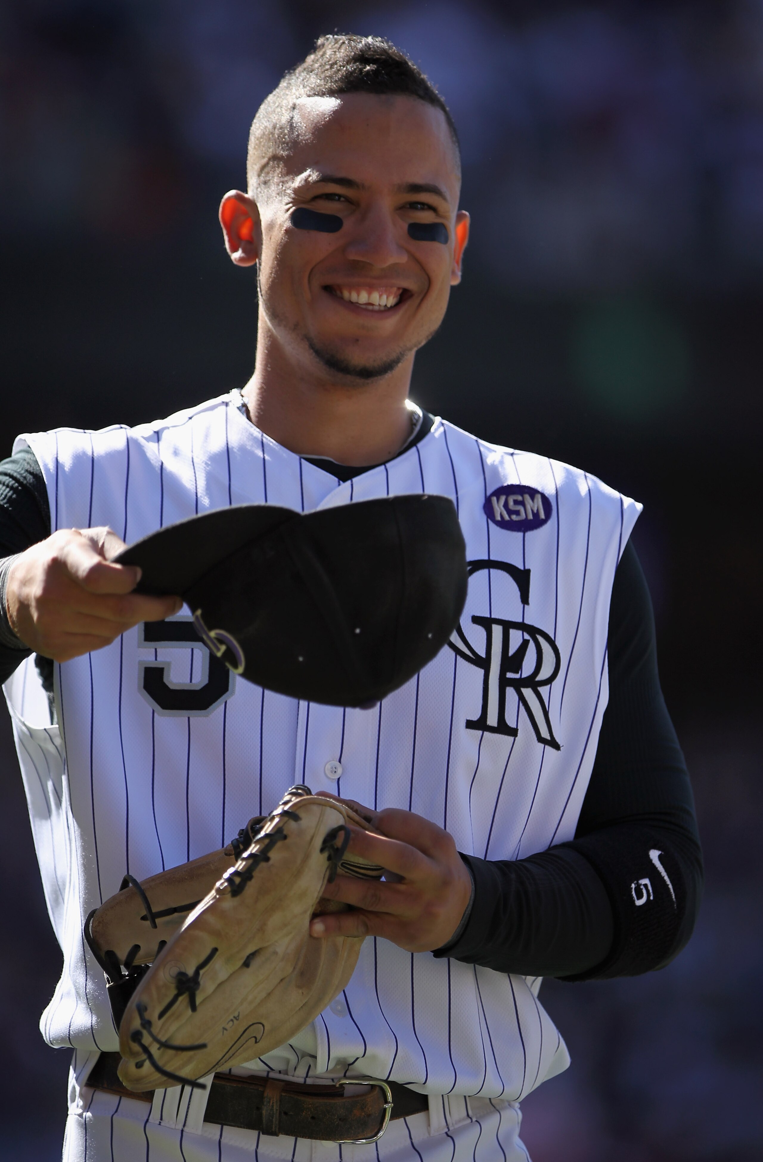 DENVER - SEPTEMBER 06:  Carlos Gonzalez #5 of the Colorado Rockies looks on as he takes the field against the Cincinnati Reds at Coors Field on September 6, 2010 in Denver, Colorado. Gonzalez went 3 for 5 and increased his average to .340 as the Rockies d
