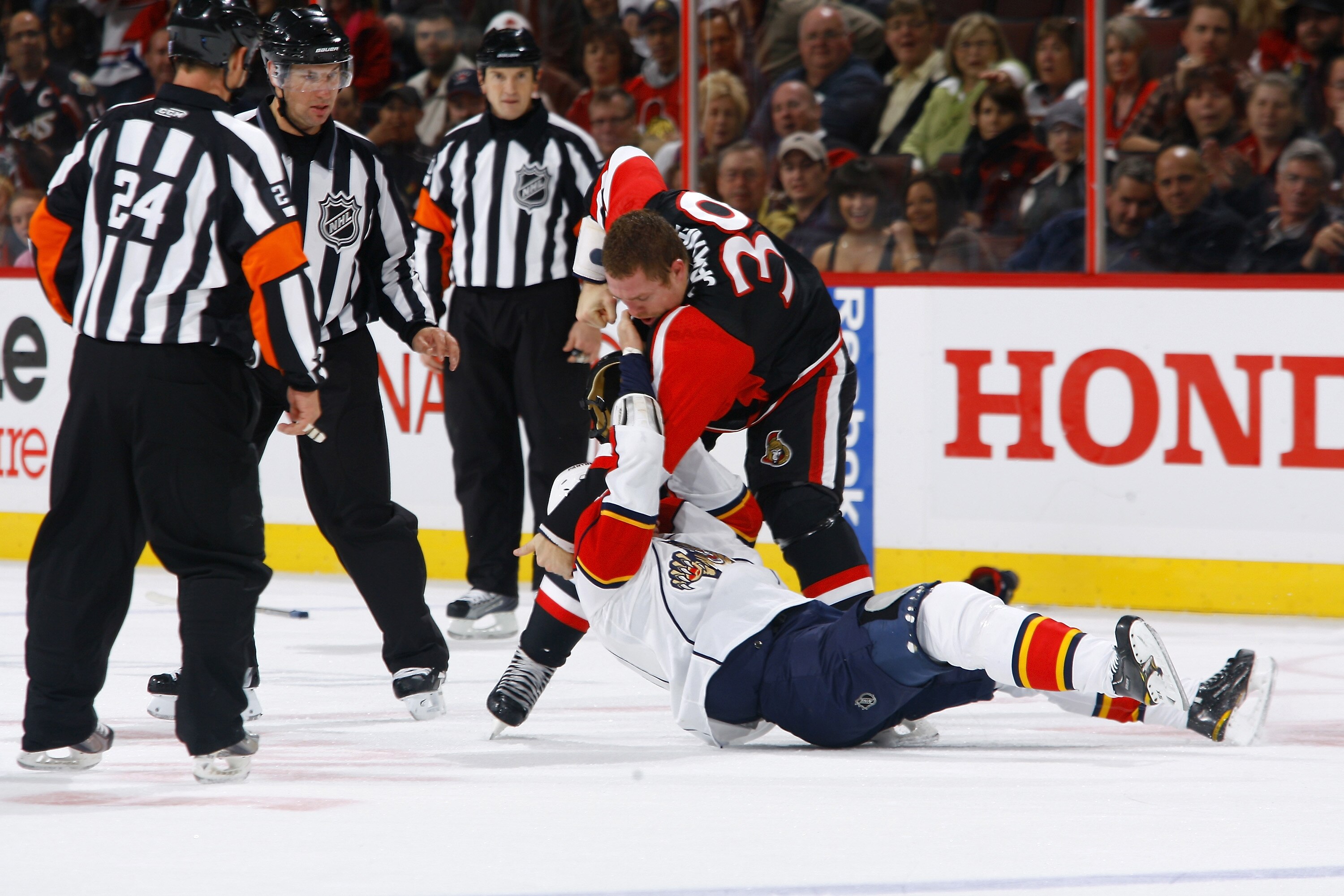 OTTAWA, ON - OCTOBER 28:  Matt Carkner #39 of the Ottawa Senators takes down Darcy Hordichuk #16 of the Florida Panthers in a fight during a game at Scotiabank Place on October 28, 2010 in Ottawa, Ontario, Canada.  (Photo by Phillip MacCallum/Getty Images