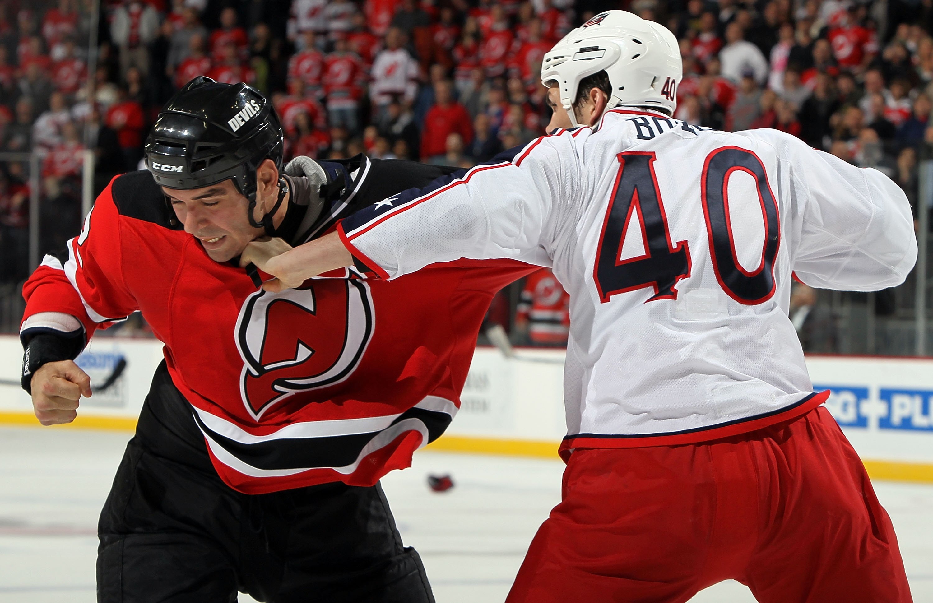 NEWARK, NJ - MARCH 23:  Jared Boll #40 of the Columbus Blue Jackets trades punches with Pierre-Luc Letourneau-Leblond #22 of the New Jersey Devils during their second period fight at the Prudential Center on March 23, 2010 in Newark, New Jersey.  (Photo b