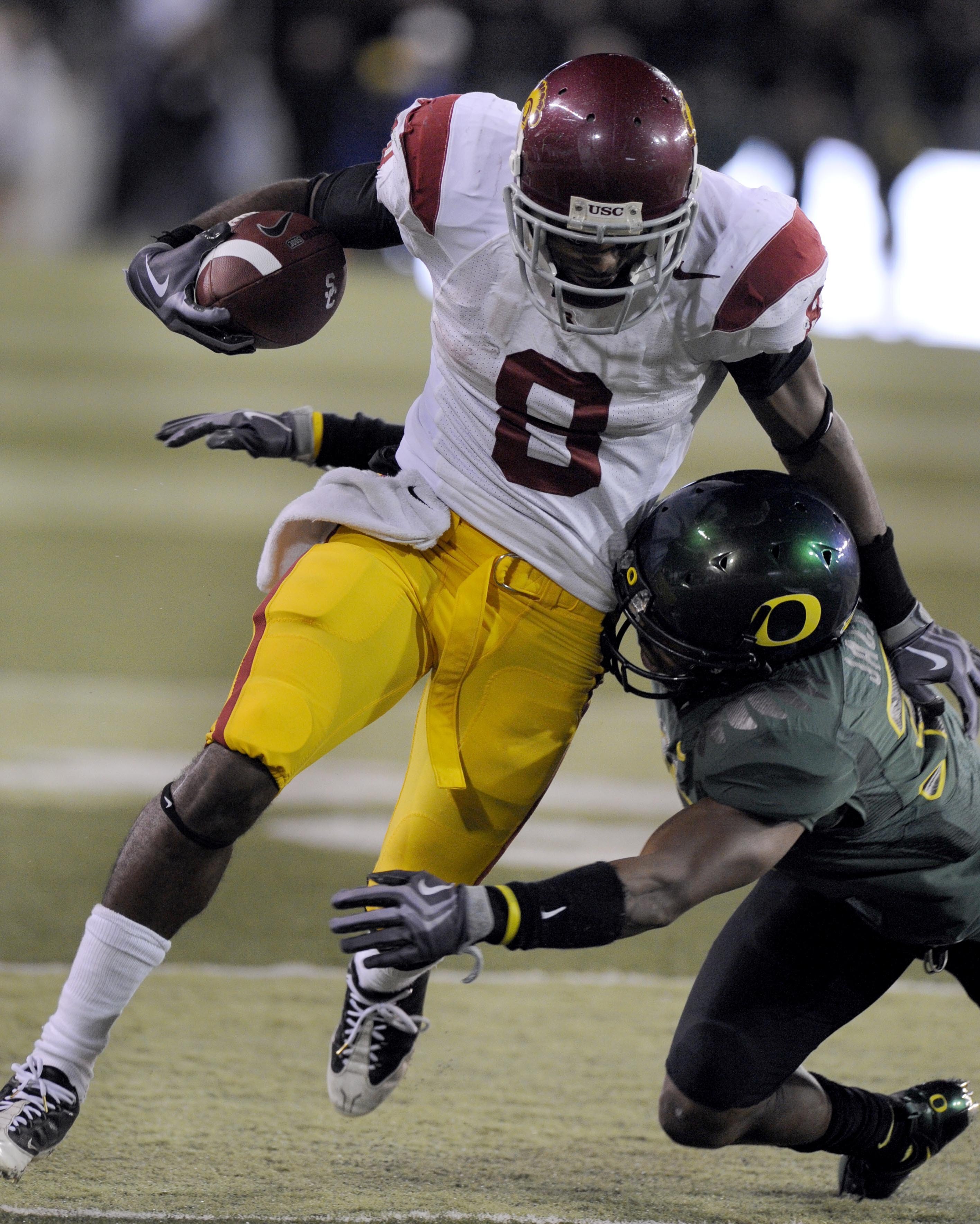 EUGENE, OR - OCTOBER 31: Wide receiver Ronald Johnson #8 of the USC Trojans is tackled by of Oregon cornerback Talmadge Jackson III in the first quarter of the game against the Oregon Ducks at Autzen Stadium on October 31, 2009 in Eugene, Oregon. Oregon d
